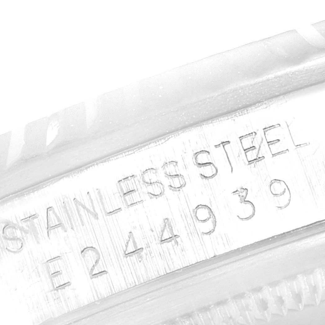 This image shows the serial number and "STAINLESS STEEL" engraving on the side of a Rolex Datejust 16234 Men's Stainless Steel Silver Dial 16234 Men's Stainless Steel Silver Dial watch case.