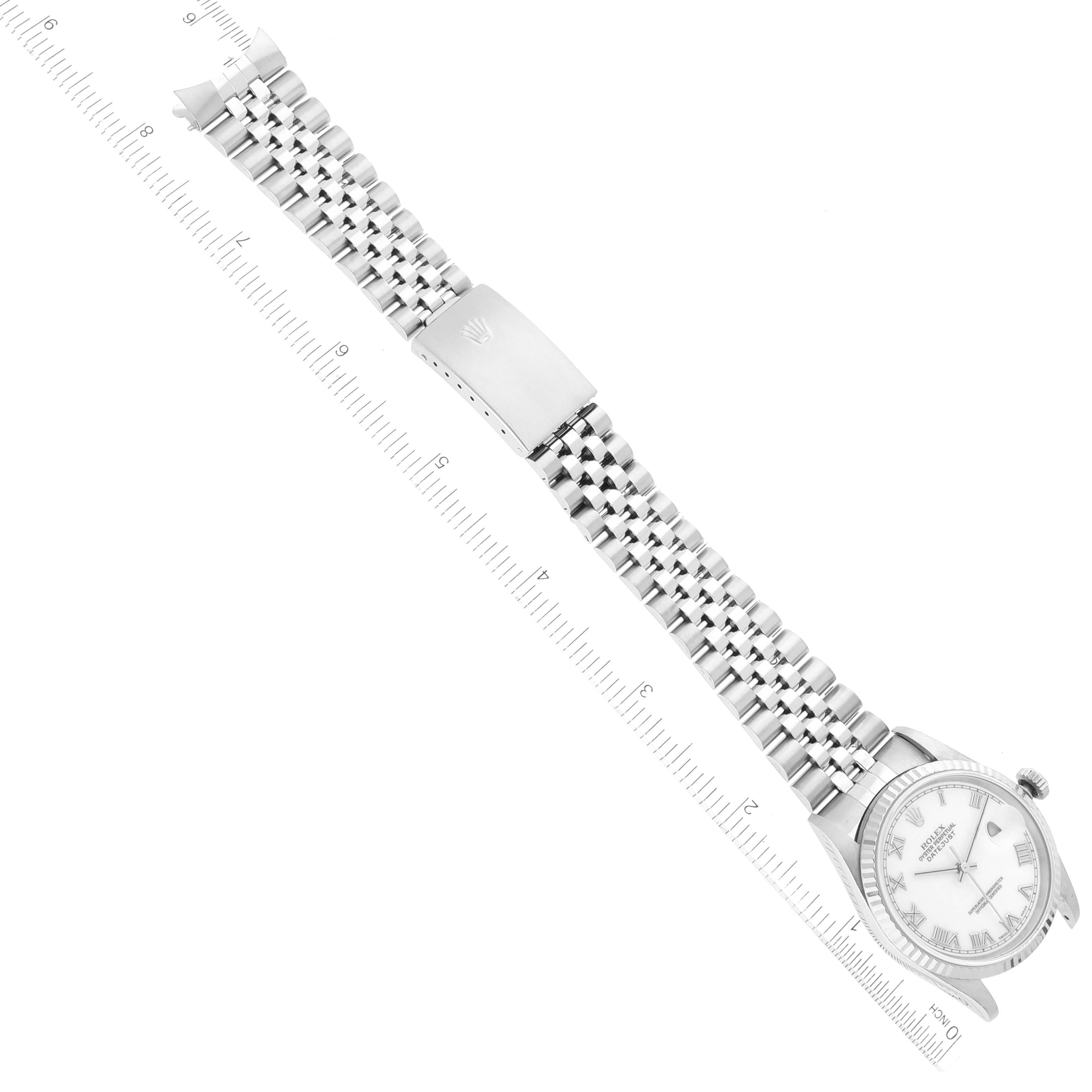 The image shows a top-down view of a Rolex Datejust 16234 Men's Stainless Steel White Dial 16234 Men's Stainless Steel White Dial watch with its full bracelet extended and a ruler for scale.