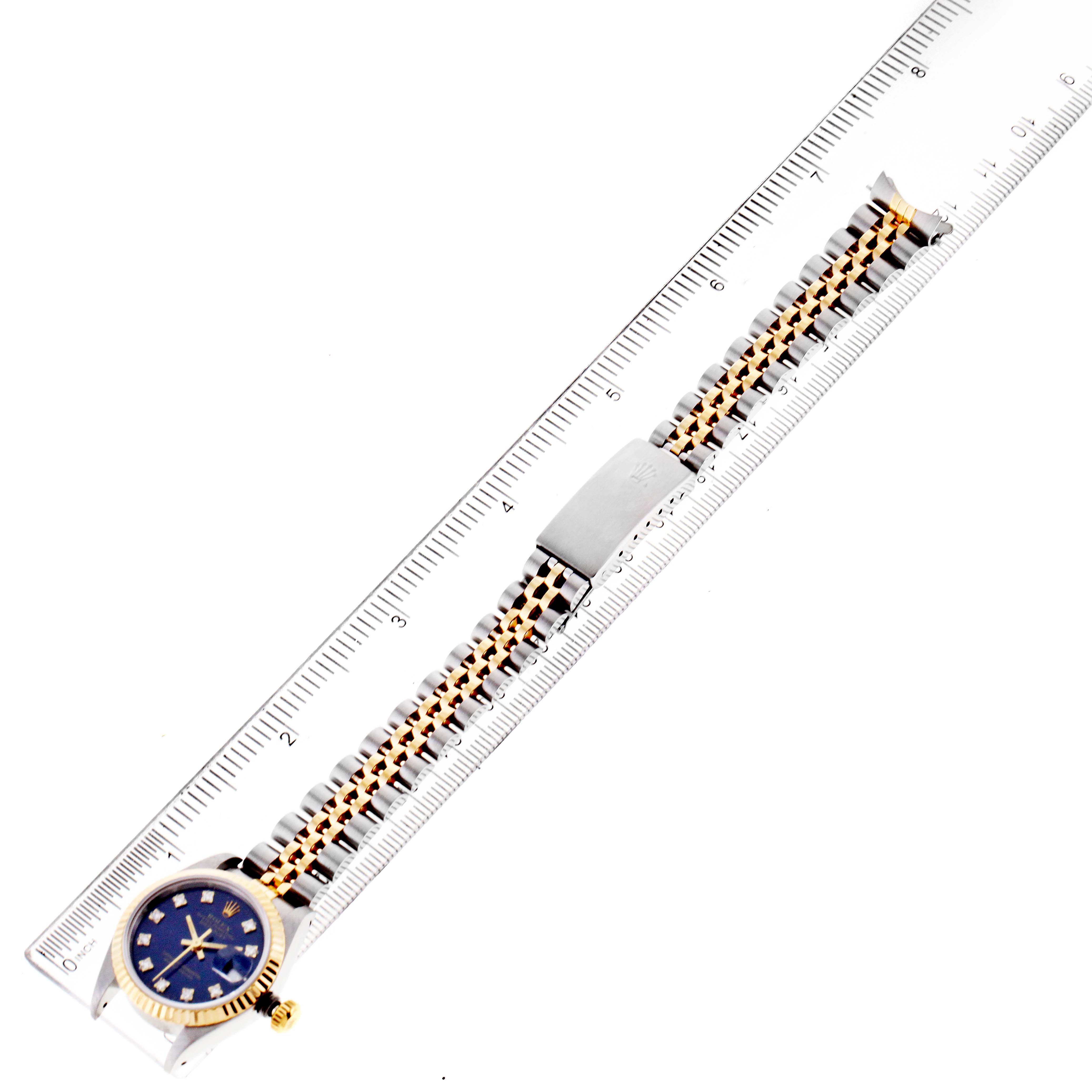 The Rolex Datejust 69173 Women's Steel and Gold (two tone) Blue Dial 69173 Women's Steel and Gold (two tone) Blue Dial watch is shown from an above angle, displaying its blue face, gold and silver link bracelet, and clasp.