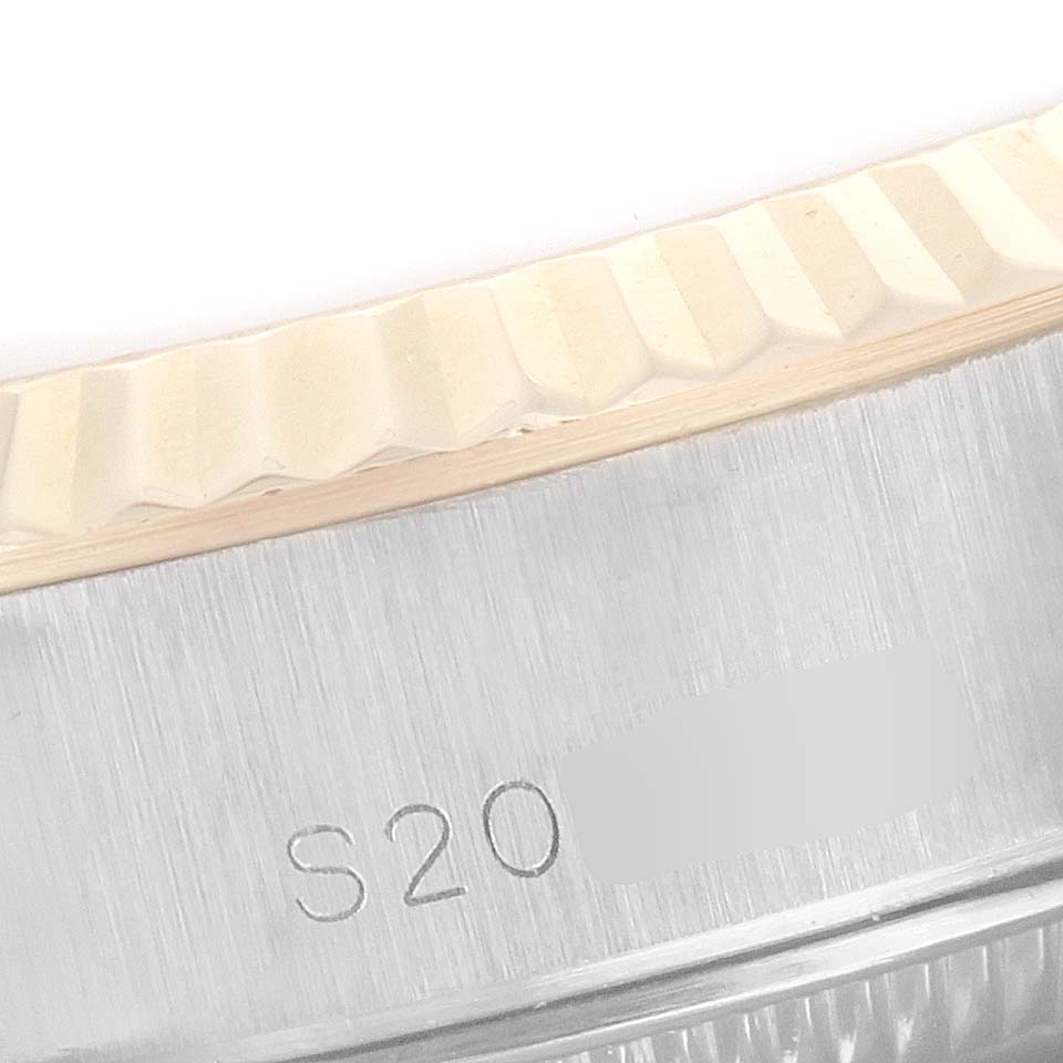 The image shows a close-up of the fluted bezel and part of the case with engraving on a Rolex Datejust 69173 Women's Steel and Gold (two tone) Blue Dial 69173 Women's Steel and Gold (two tone) Blue Dial watch.