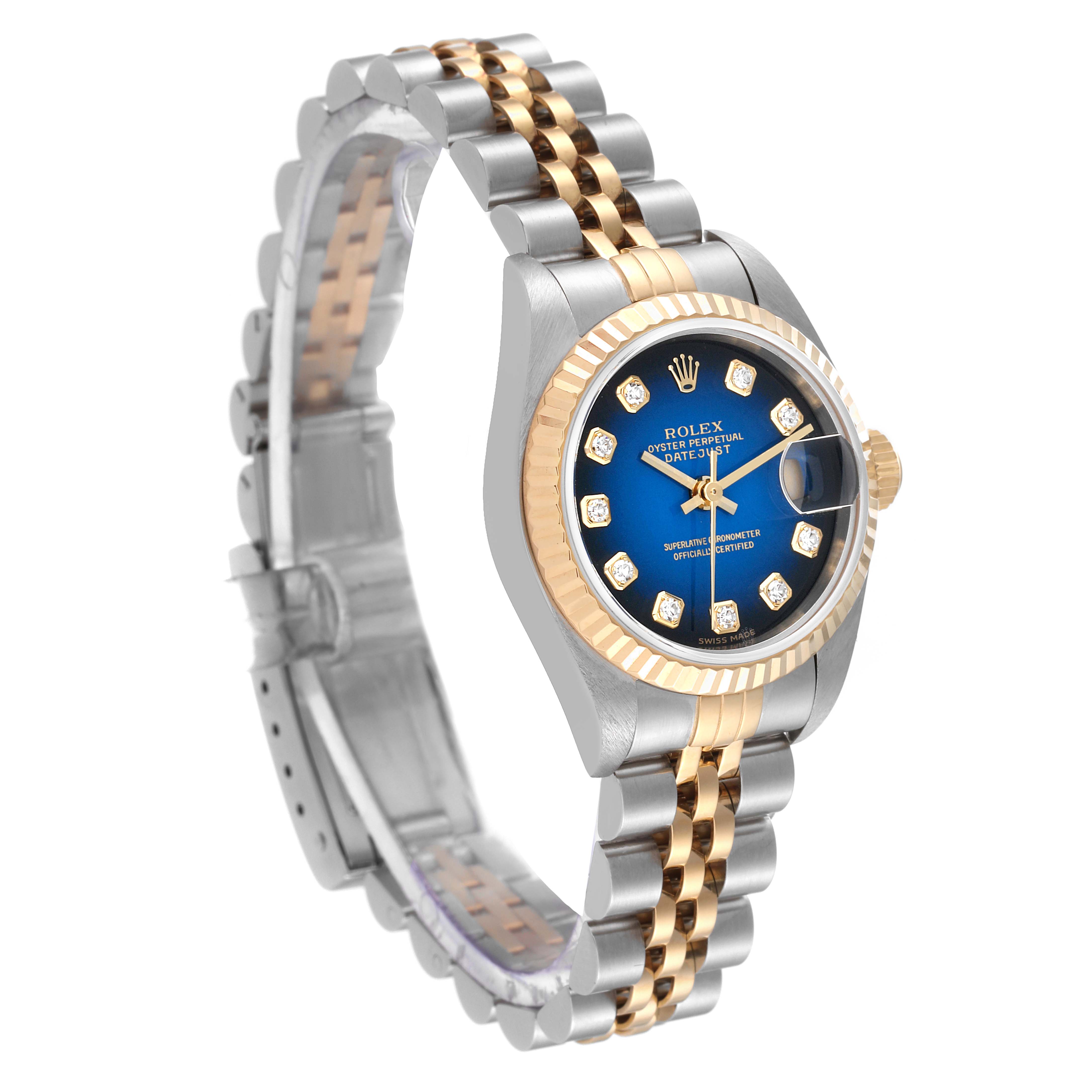 The image shows a side view of a Rolex Datejust 79173 Women's Steel and Gold (two tone) Blue Dial 79173 Women's Steel and Gold (two tone) Blue Dial watch, highlighting its two-tone bracelet, blue dial, and fluted bezel.