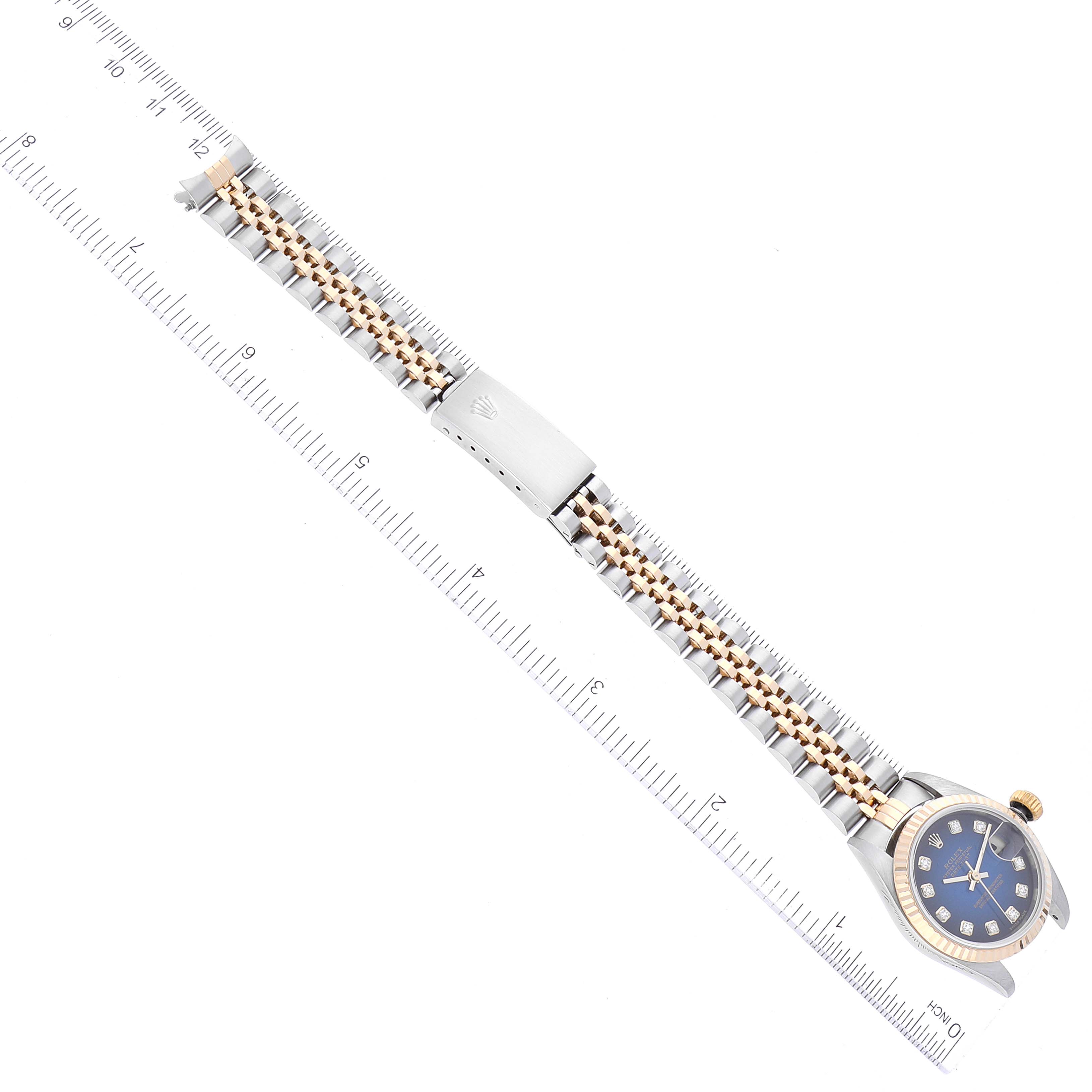 The image shows a Rolex Datejust 79173 Women's Steel and Gold (two tone) Blue Dial 79173 Women's Steel and Gold (two tone) Blue Dial watch, laying flat with a ruler beneath it, displaying the bracelet, bezel, and dial.
