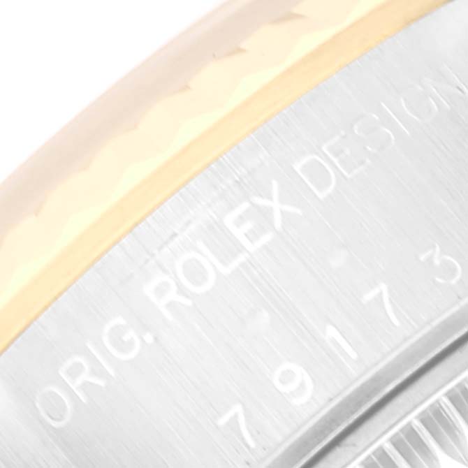 A close-up angle shows the engraved "ORIG. ROLEX DESIGN" text on the casing of the Rolex Datejust 79173 Women's Steel and Gold (two tone) Blue Dial 79173 Women's Steel and Gold (two tone) Blue Dial model.