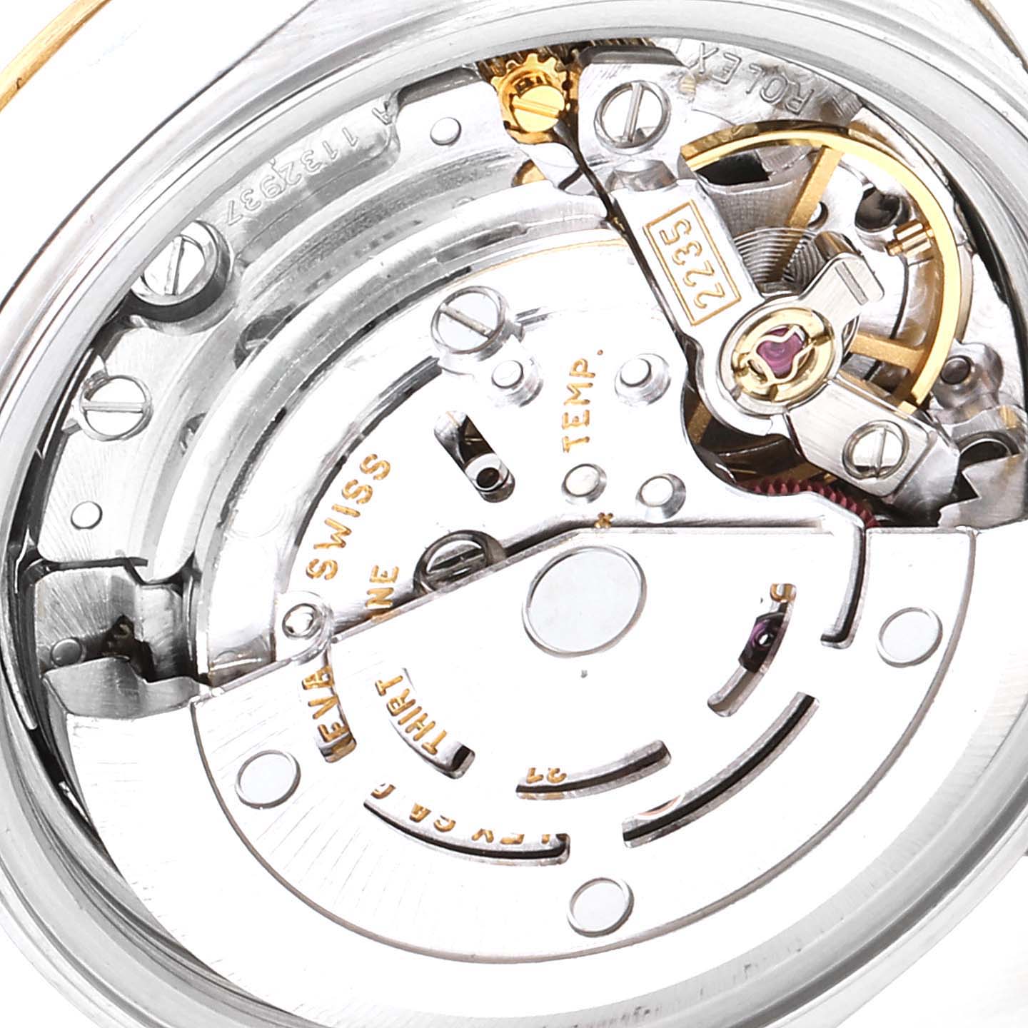 This macro shot of the Rolex Datejust 79163 Women's Steel and Gold (two tone) Silver Dial 79163 Women's Steel and Gold (two tone) Silver Dial watch shows the intricate details of its movement mechanism.