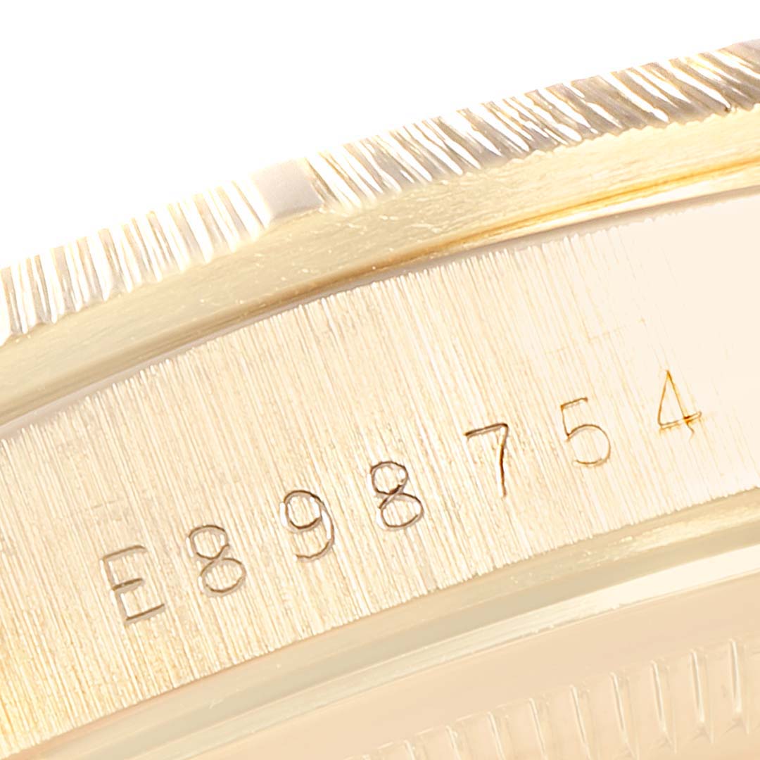 This image shows a close-up of the case and bezel with serial number on the Rolex President 18248 Men
s Yellow Gold Silver Dial 18248 Men
s Yellow Gold Silver Dial model watch.