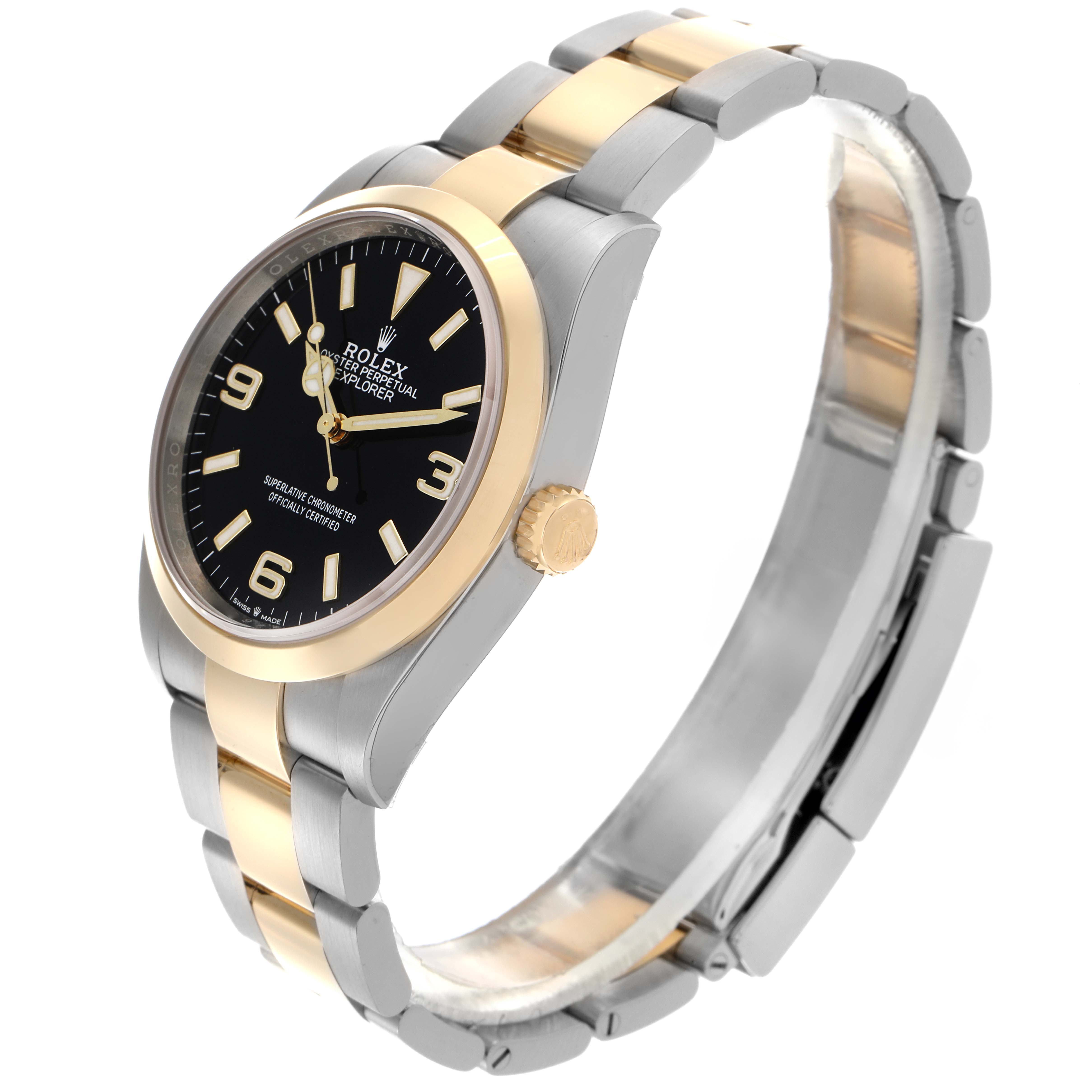 The Rolex Explorer 124273 Men's Steel and Gold (two tone) Black Dial 124273 Men's Steel and Gold (two tone) Black Dial model is shown at a high angle, highlighting the black dial, gold bezel and crown, and two-tone metal bracelet.
