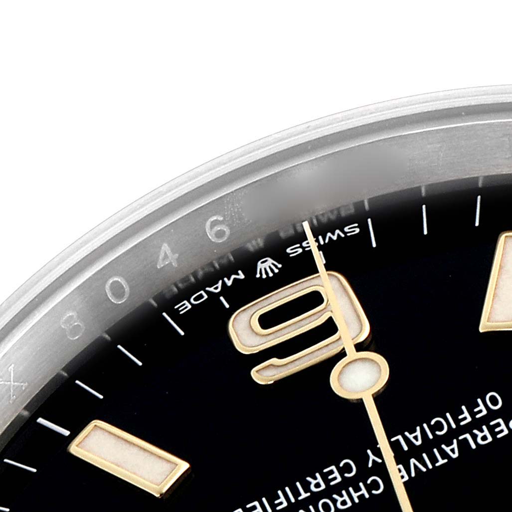 The image shows a close-up of the dial of a Rolex Explorer 124273 Men's Steel and Gold (two tone) Black Dial 124273 Men's Steel and Gold (two tone) Black Dial watch, featuring part of the bezel, numerals, and a portion of the minute hand.