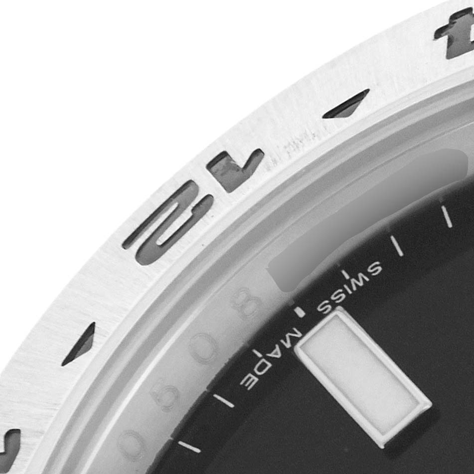 This image shows a close-up of the Rolex Explorer 216570 Men
s Stainless Steel Black Dial 216570 Men
s Stainless Steel Black Dial model
s bezel, part of the dial, and the "Swiss Made" designation.