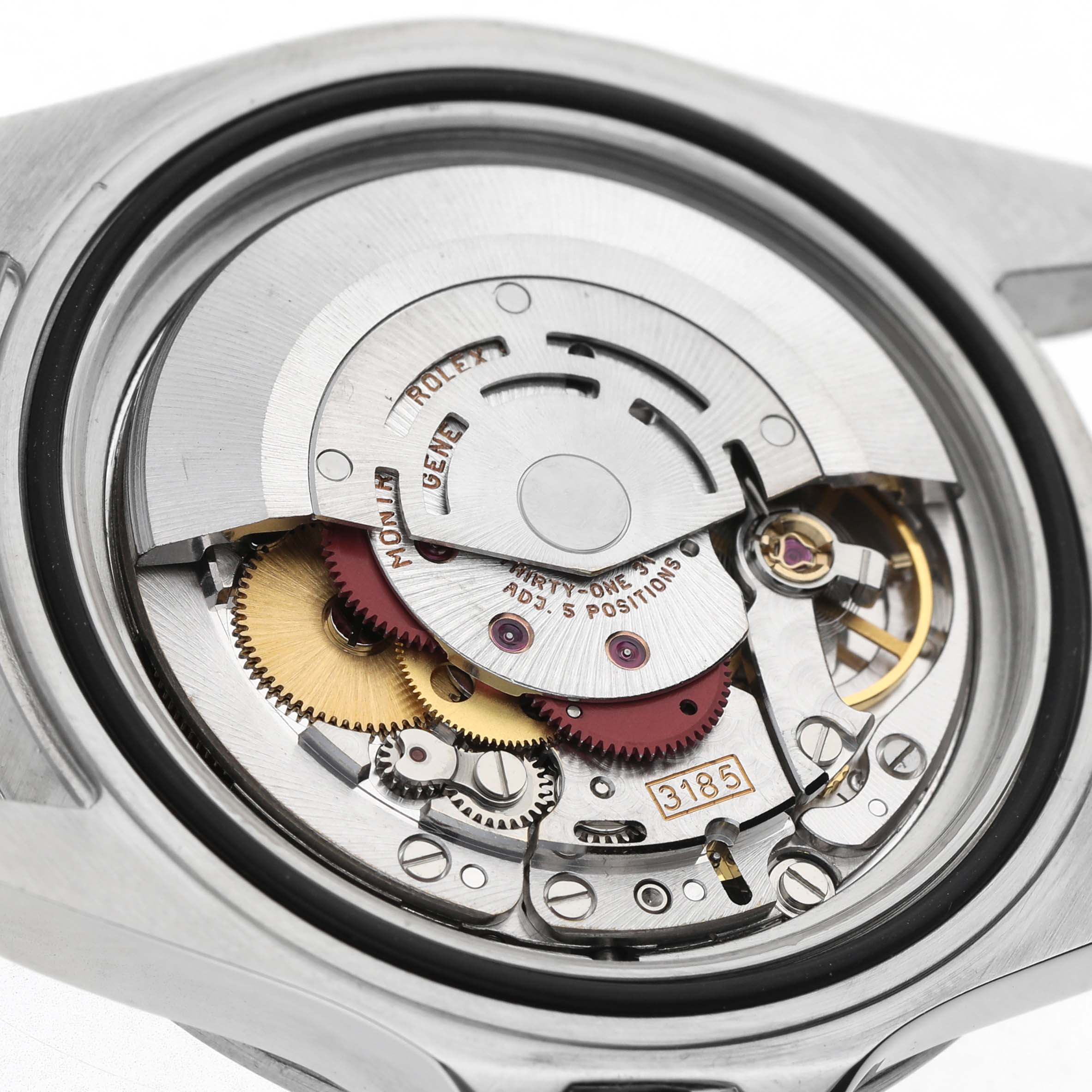 The image shows the movement of a Rolex Explorer 16570 Men's Stainless Steel White Dial watch from a top-down angle, highlighting gears and the rotor.