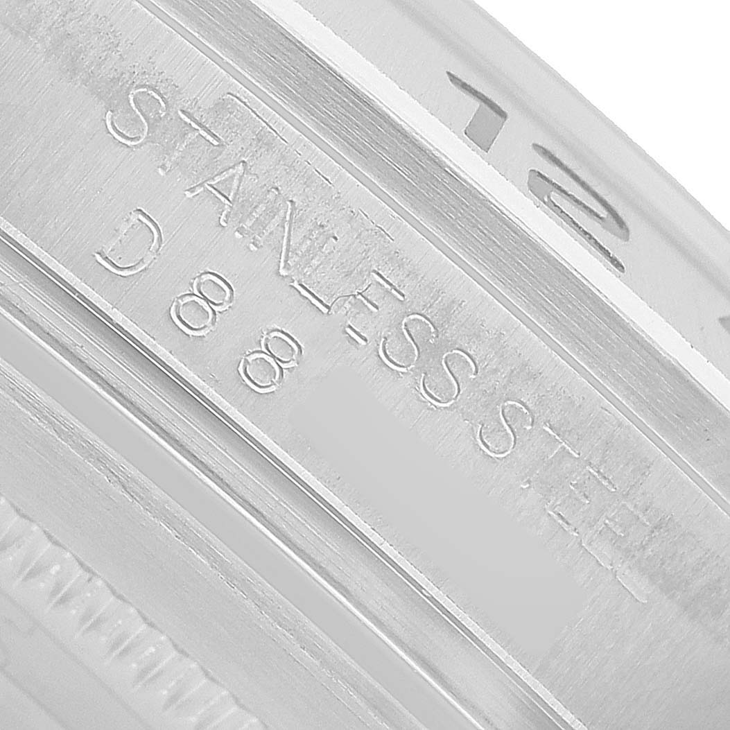 The image shows a close-up of the engraving on the side of a Rolex Explorer 16570 T Men's Stainless Steel White Dial watch, highlighting "STAINLESS STEEL."