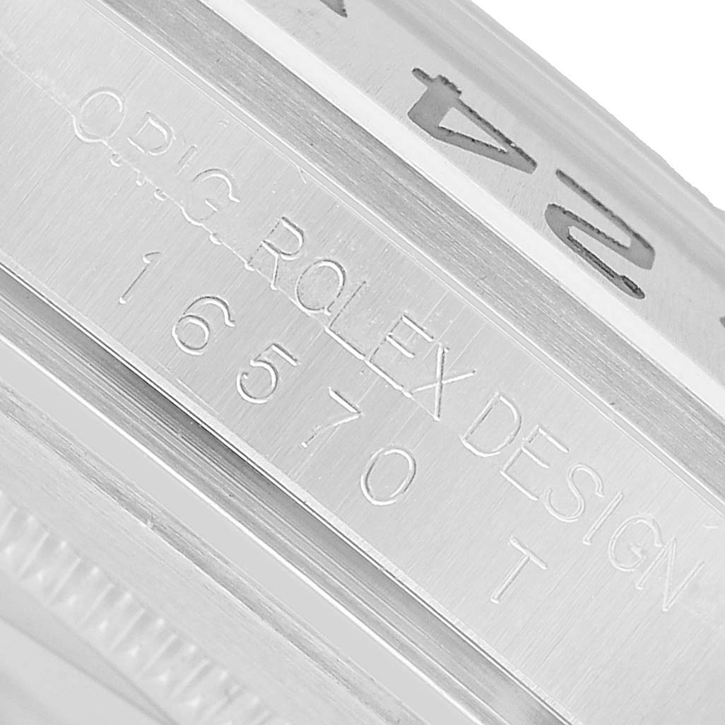 The image shows the side view of a Rolex Explorer 16570 T Men's Stainless Steel White Dial, focusing on the engraved model number.