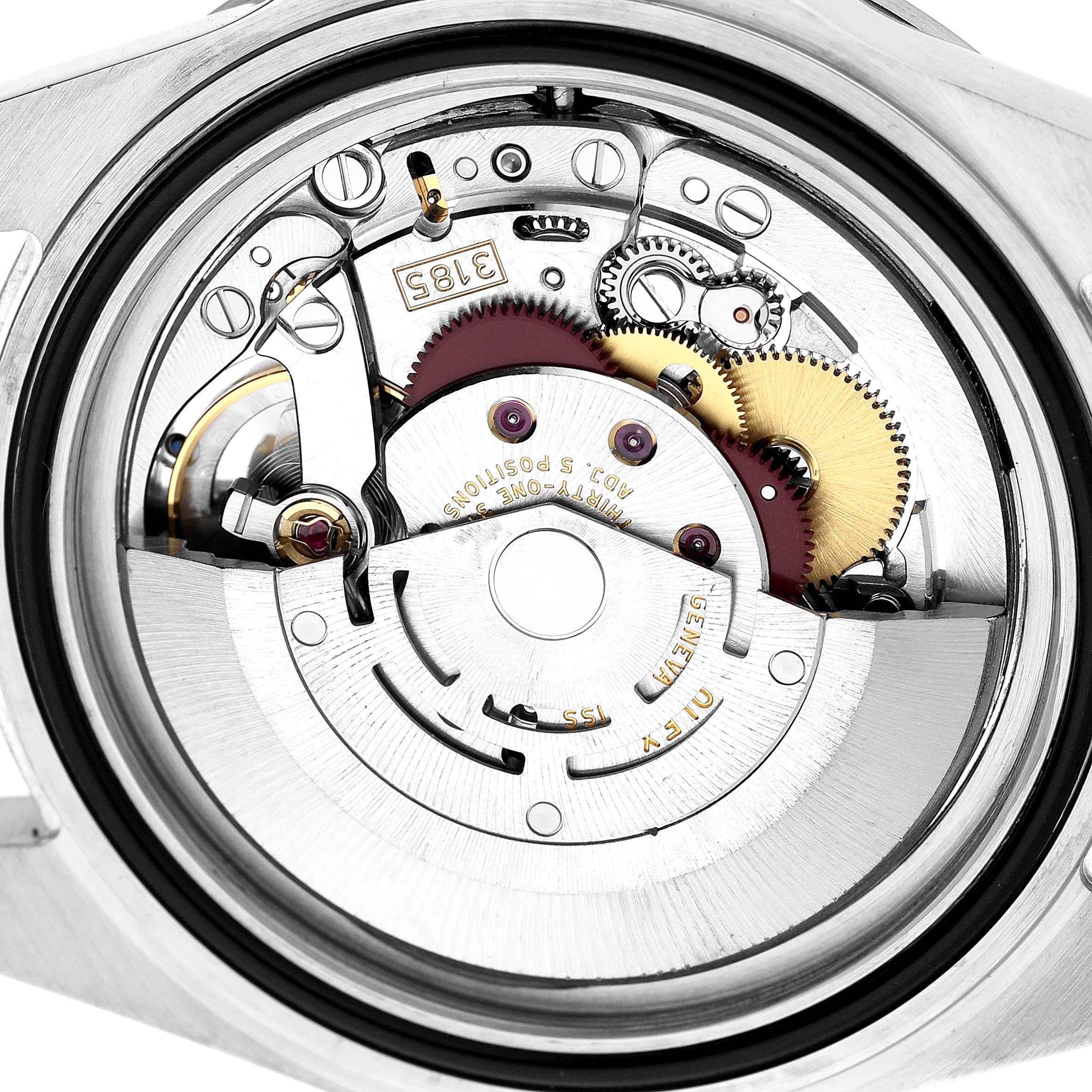The image shows the internal movement of a Rolex Explorer 16570 T Men's Stainless Steel White Dial watch from a back view, highlighting its gears and rotor.