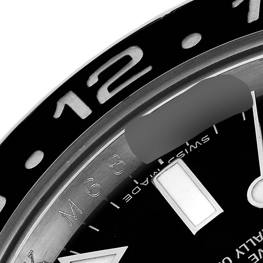This image shows a close-up angle of the bezel and part of the dial of a Rolex GMT-Master 116710 Men
s Stainless Steel Black Dial 116710 Men
s Stainless Steel Black Dial watch.