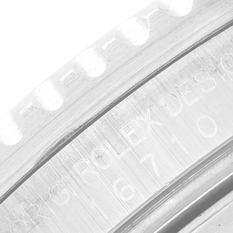 This close-up image shows the engraved bezel edge and part of the side casing of a Rolex GMT-Master 16710 Men
s Stainless Steel Black Dial 16710 Men
s Stainless Steel Black Dial watch.