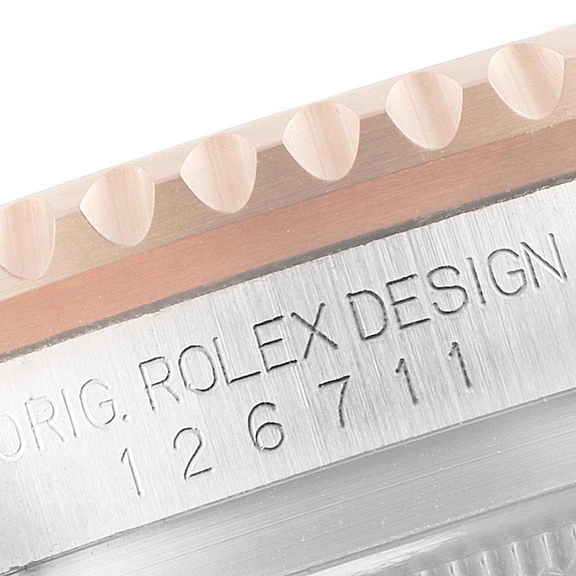 A close-up of the Rolex GMT-Master 126711 Men
s Stainless Steel Black Dial 126711 Men
s Stainless Steel Black Dial watch showing the edge of the bezel and engraved model and brand markings.