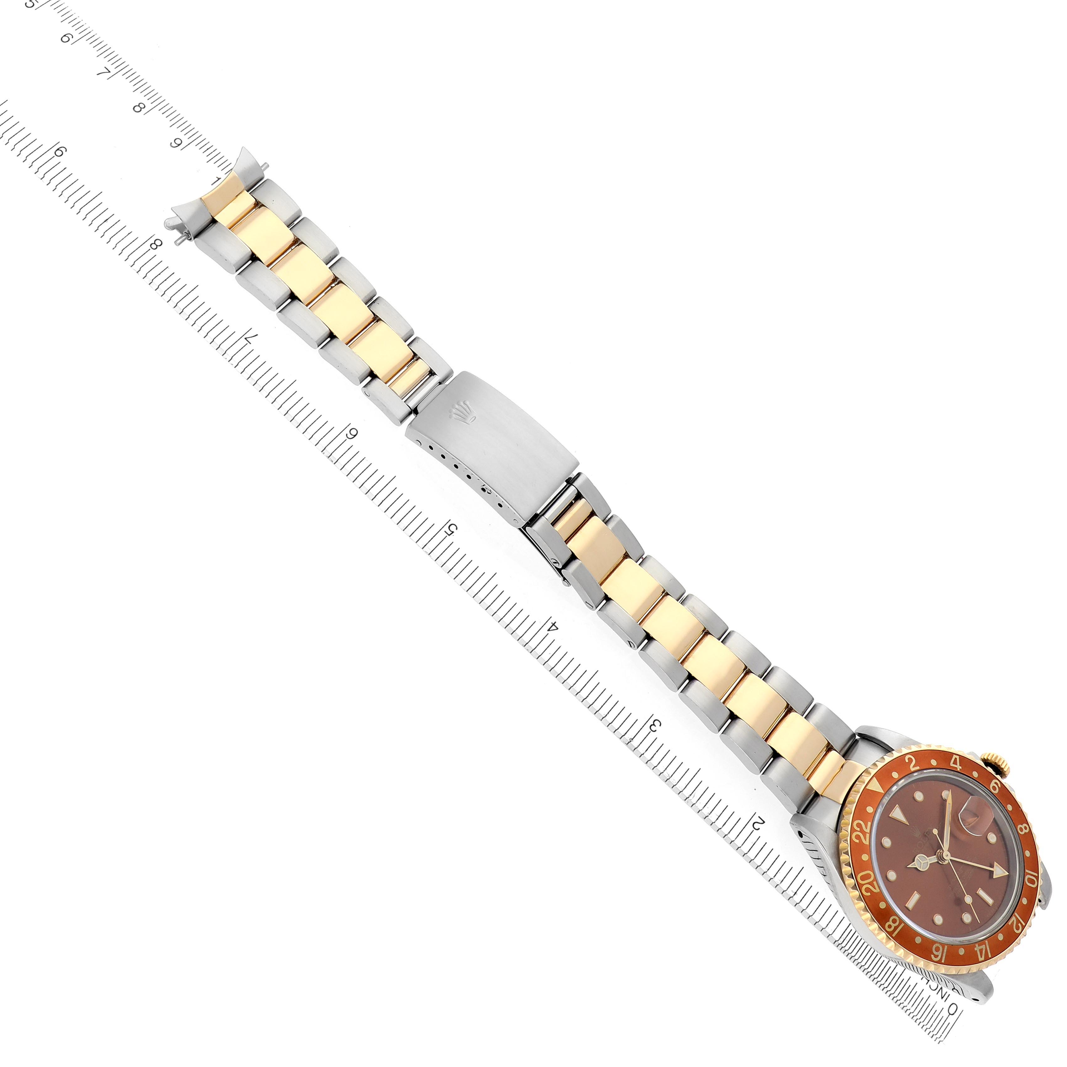 The Rolex GMT-Master 16713 Men's Steel and Gold (two tone) Brown Dial 16713 Men's Steel and Gold (two tone) Brown Dial watch is shown at a top-down angle, highlighting the bezel, dial, and bracelet with its clasp.