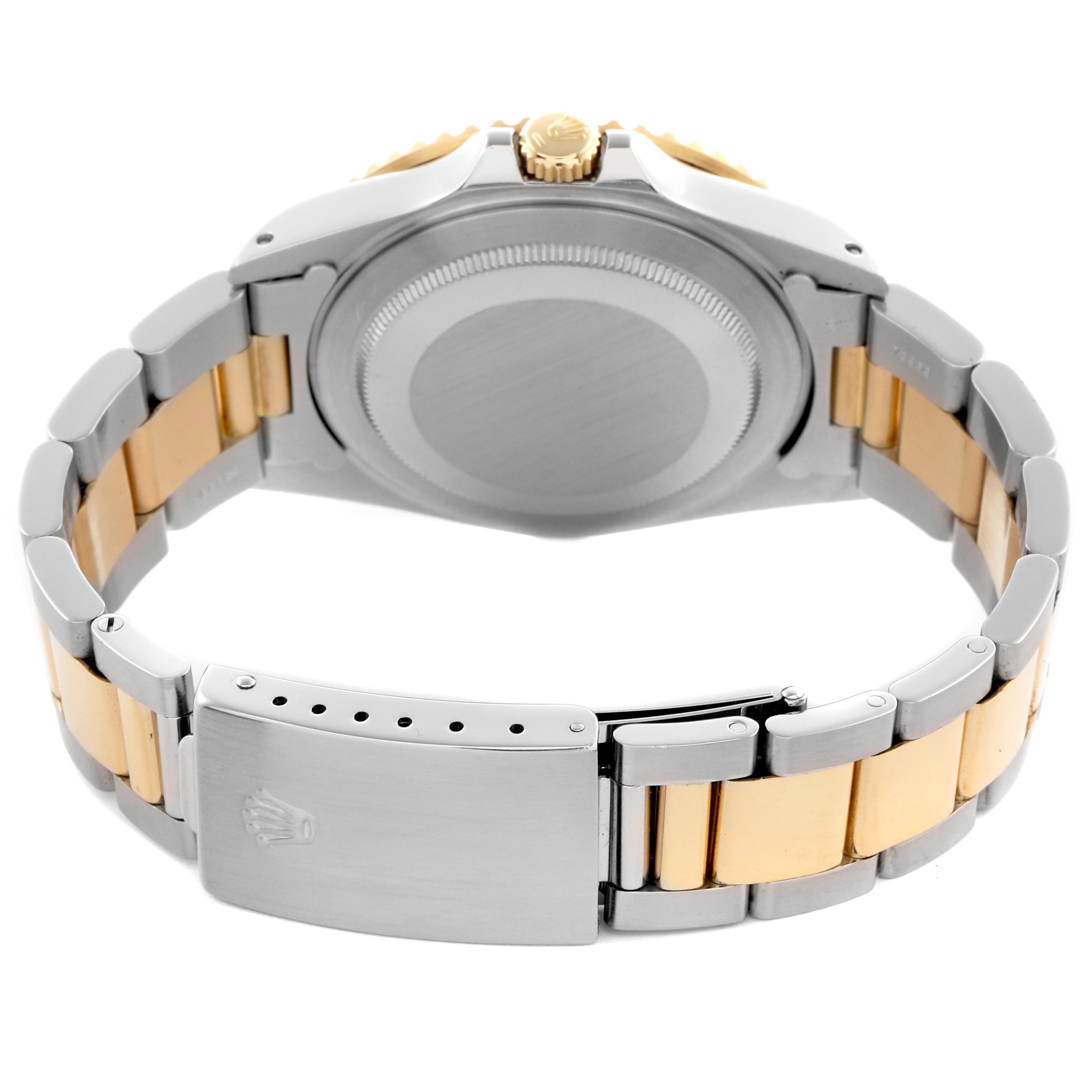 The image shows the back of a Rolex GMT-Master 16713 Men's Steel and Gold (two tone) Brown Dial 16713 Men's Steel and Gold (two tone) Brown Dial watch, focusing on the case, crown, and two-tone bracelet.