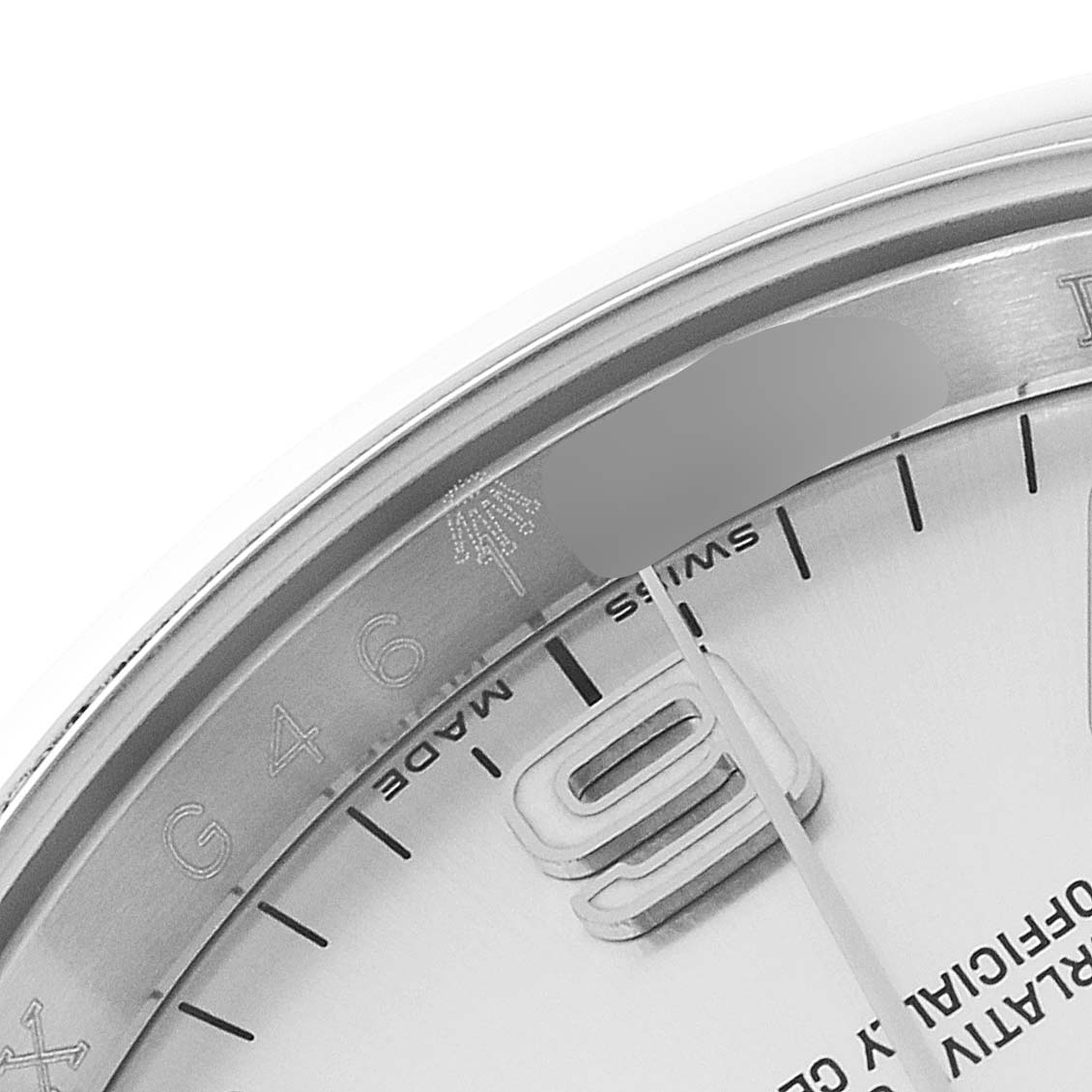 The image shows a close-up of the dial, bezel, and hour markers of a Rolex Oyster Perpetual 116000 Men's Stainless Steel Silver Dial 116000 Men's Stainless Steel Silver Dial watch.