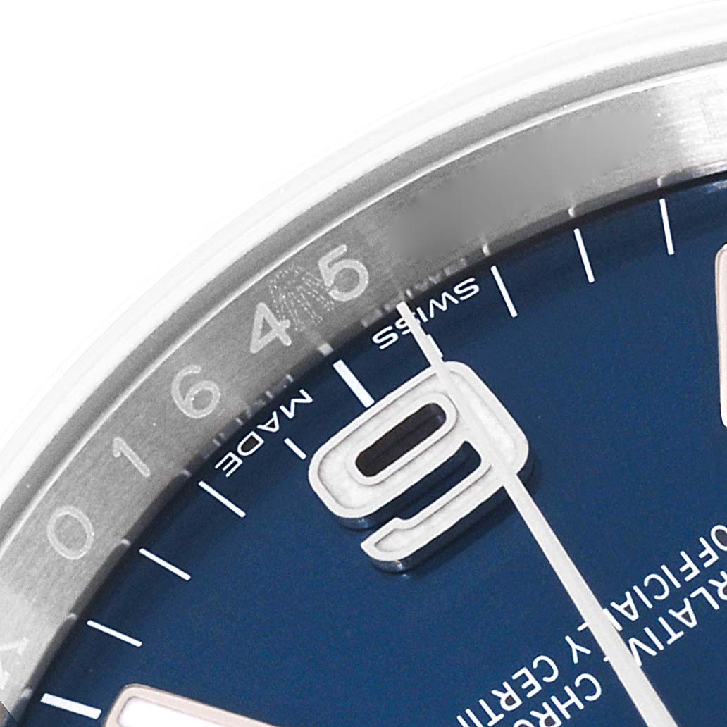 This image shows a close-up of the dial and bezel of a Rolex Oyster Perpetual 116000 Men's Stainless Steel Blue Dial 116000 Men's Stainless Steel Blue Dial watch, focusing on the 4, 5, 6 numbers and surrounding markers.