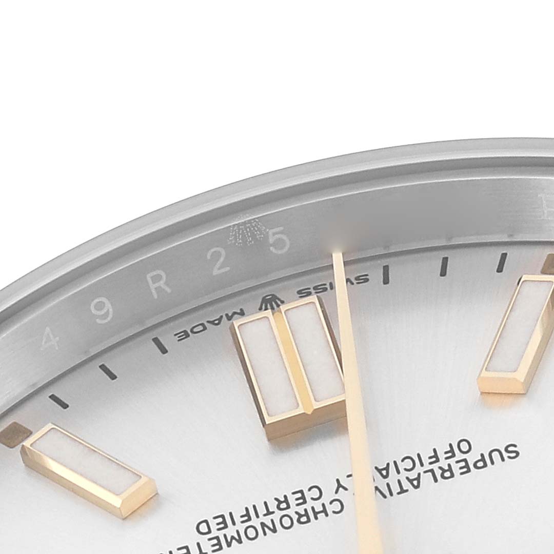 This image shows a close-up of the dial and indices of a Rolex Oyster Perpetual 124300 Men's Stainless Steel Silver Dial 124300 Men's Stainless Steel Silver Dial watch, highlighting parts of the text and minute markers.