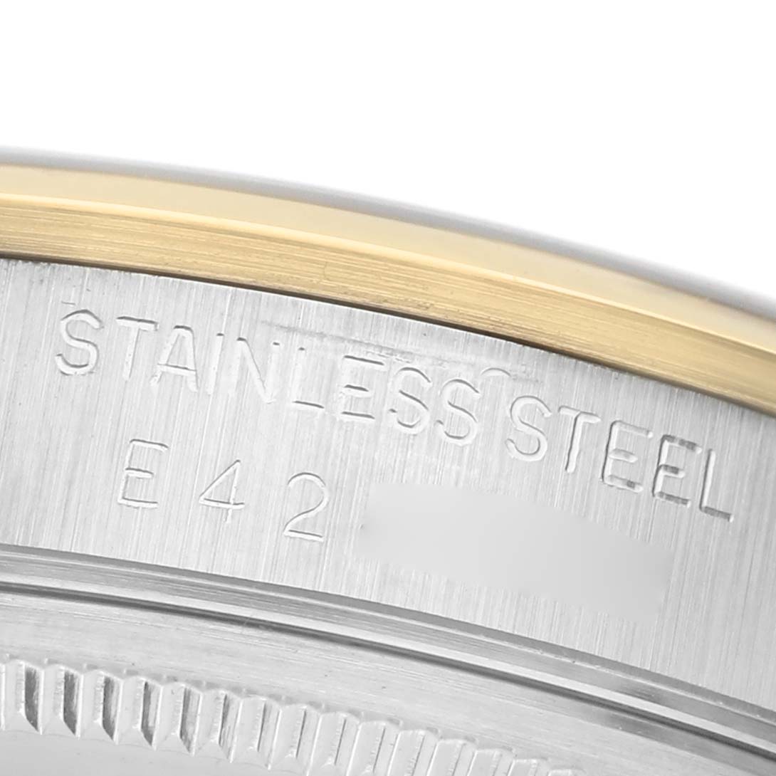 The image shows a close-up of the stainless steel case side and part of the bezel of a Rolex Oyster Perpetual 14203 Men's Steel and Gold (two tone) White Dial watch.