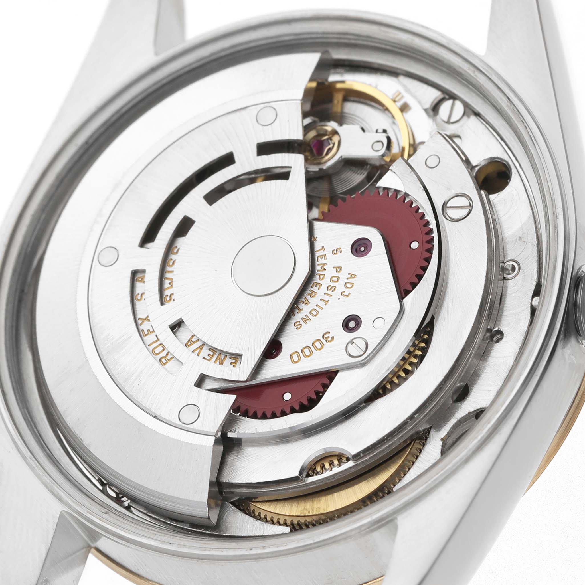 The image shows the internal mechanical movement of a Rolex Oyster Perpetual 14203 Men's Steel and Gold (two tone) White Dial, displaying gears and the rotor from a rear angle.
