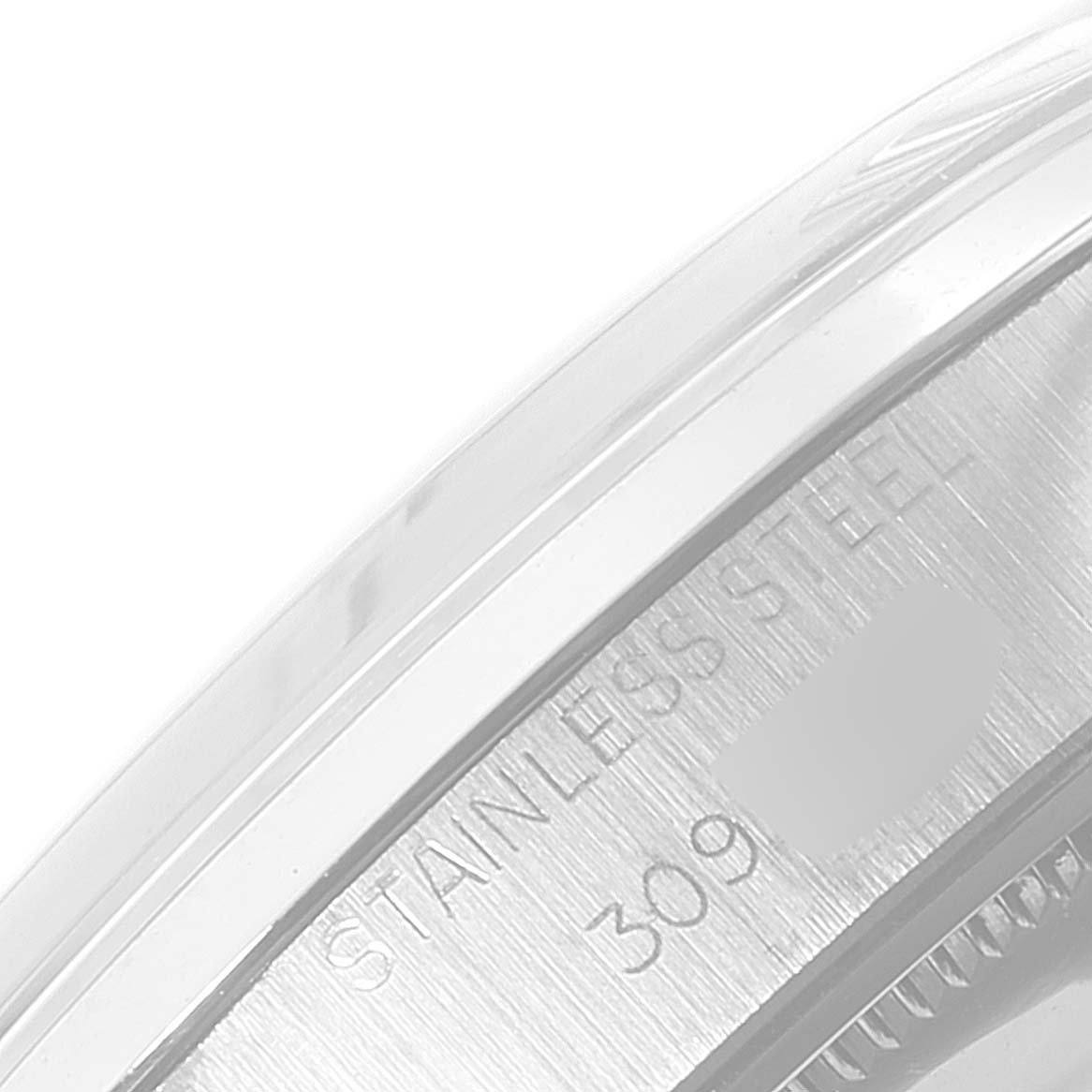 This image shows a close-up of the case side of a Rolex Date 6694 Men's Stainless Steel Silver Dial 6694 Men's Stainless Steel Silver Dial model, highlighting the "Stainless Steel" engraving.