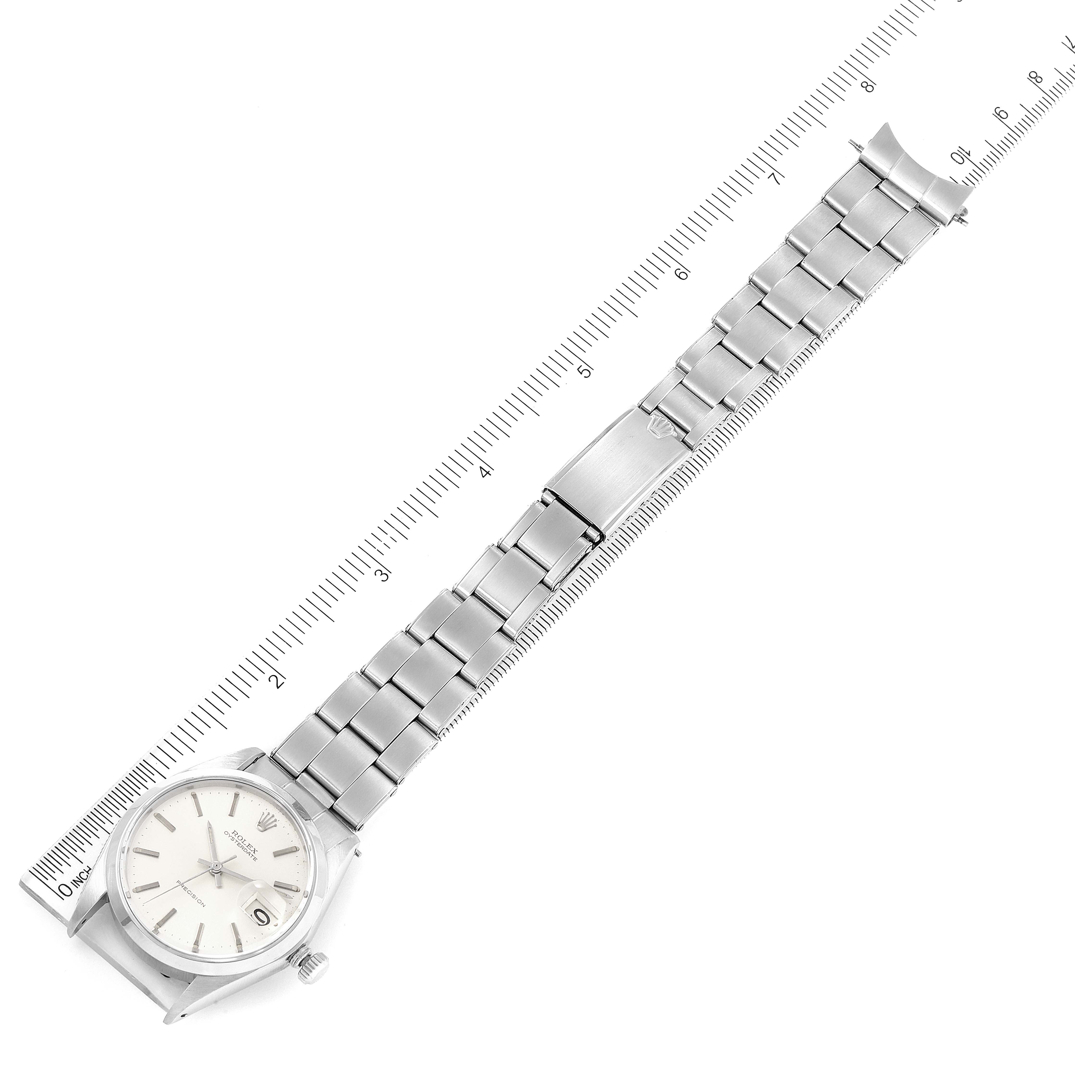 The Rolex Vintage Collection 6694 Men's Stainless Steel Silver Dial 6694 Men's Stainless Steel Silver Dial watch is shown laid flat with the face and entire bracelet visible, aligned next to a ruler.