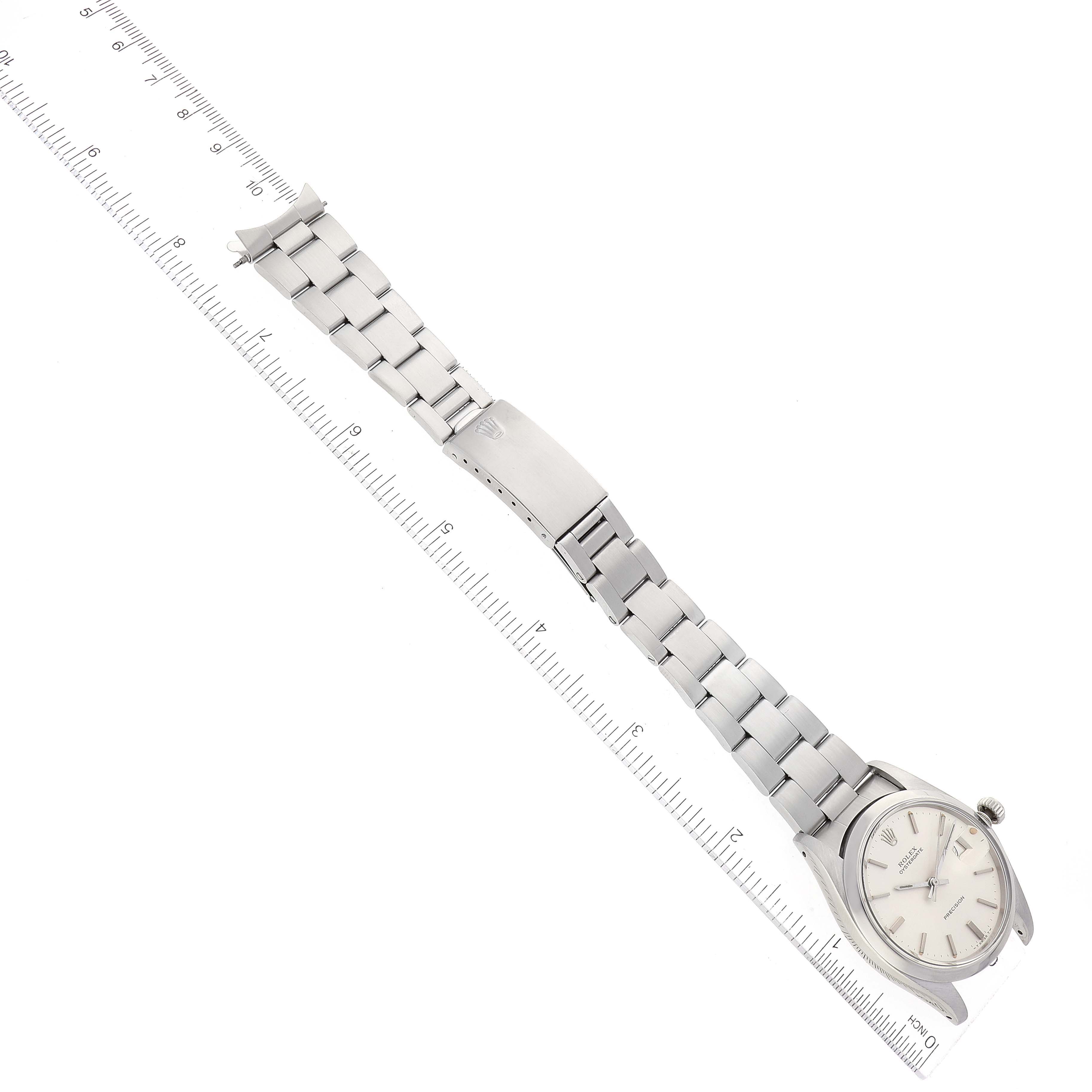 This image shows the vintage Rolex watch model from the Vintage Collection laid flat, highlighting its bracelet, clasp, and dial at an overhead angle.