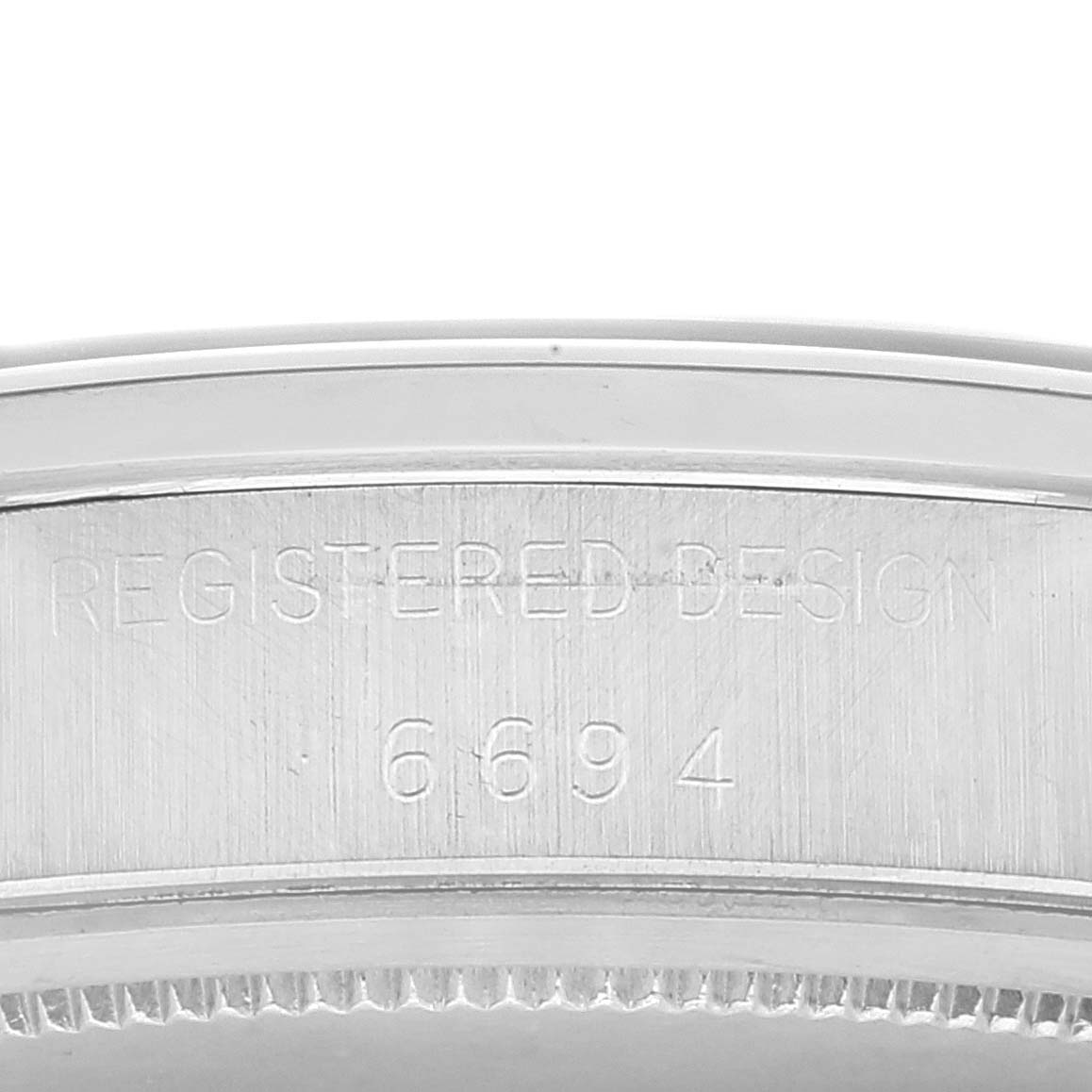 This image shows a close-up view of the engraved caseback of the Vintage Collection model by Rolex, showcasing the design and serial number.