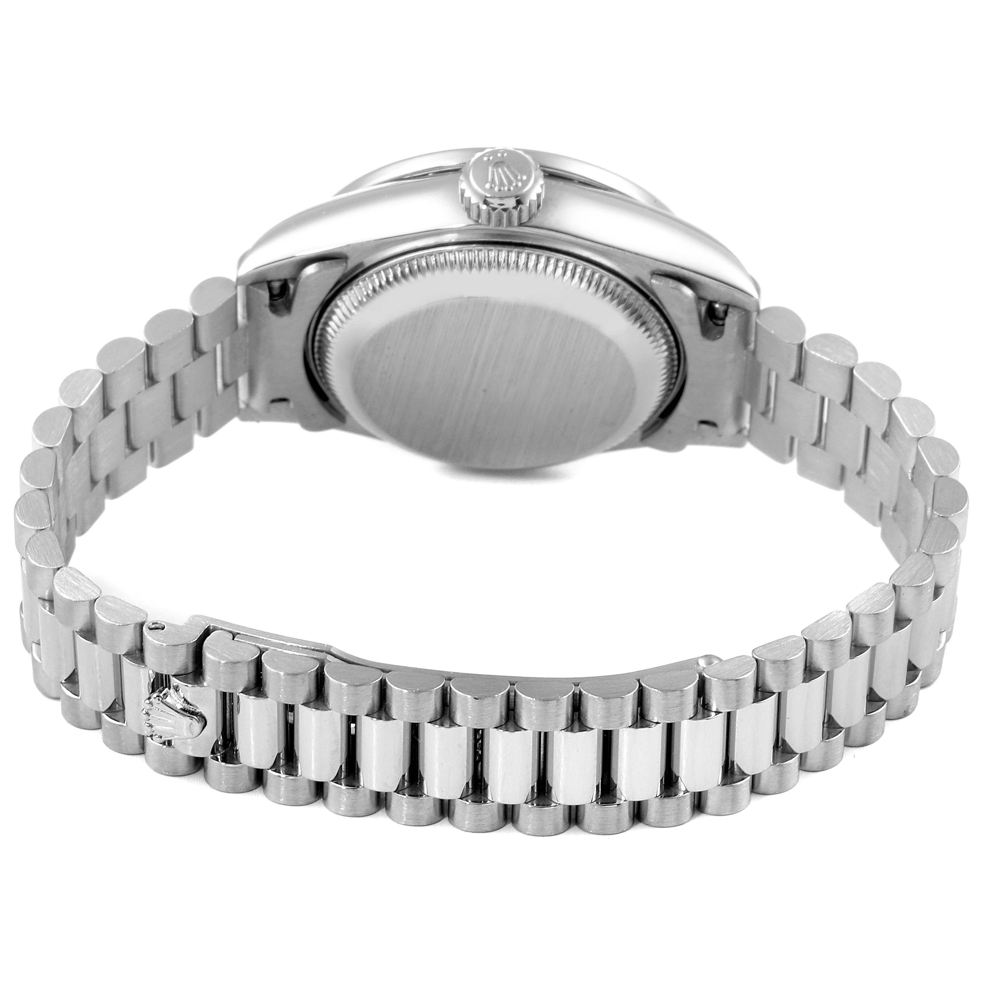 The image shows the back view of a Rolex President 79089 Women's White Gold Silver Dial 79089 Women's White Gold Silver Dial watch, highlighting its case, crown, and linked bracelet.