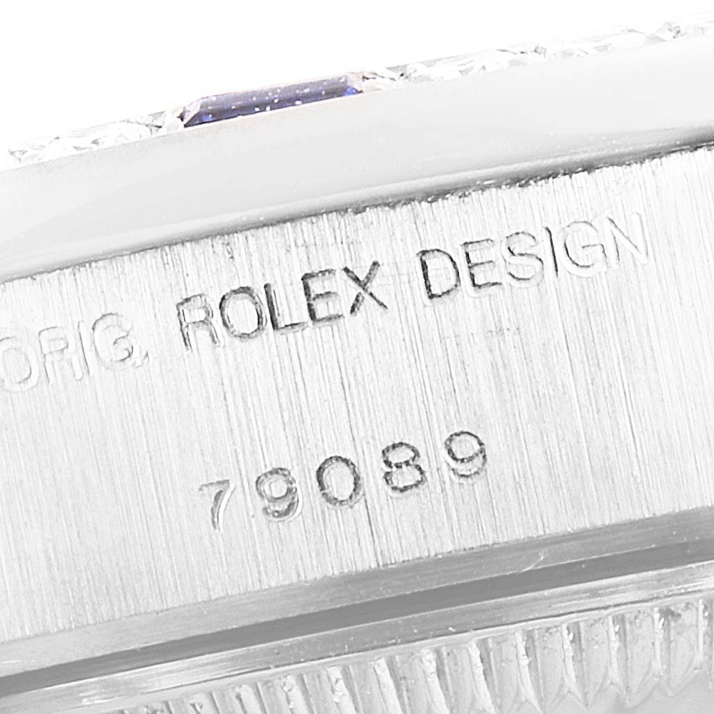 The image shows a close-up of the case side of a Rolex President 79089 Women's White Gold Silver Dial 79089 Women's White Gold Silver Dial model watch, featuring engravings of "ROLEX DESIGN" and a reference number.