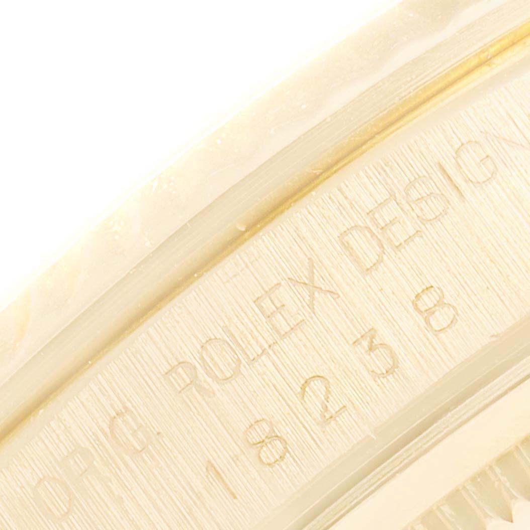 The image shows a close-up of the inner bezel of a Rolex President 18238 Men
s Yellow Gold Champagne Dial 18238 Men
s Yellow Gold Champagne Dial model watch, featuring its engraved serial numbers.