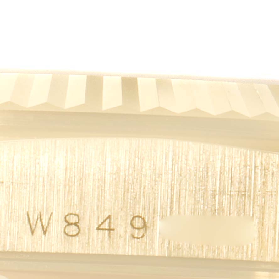 The close-up image shows the side of a Rolex President 18238 Men
s Yellow Gold Champagne Dial 18238 Men
s Yellow Gold Champagne Dial model watch, focusing on the serial number and part of the bezel.