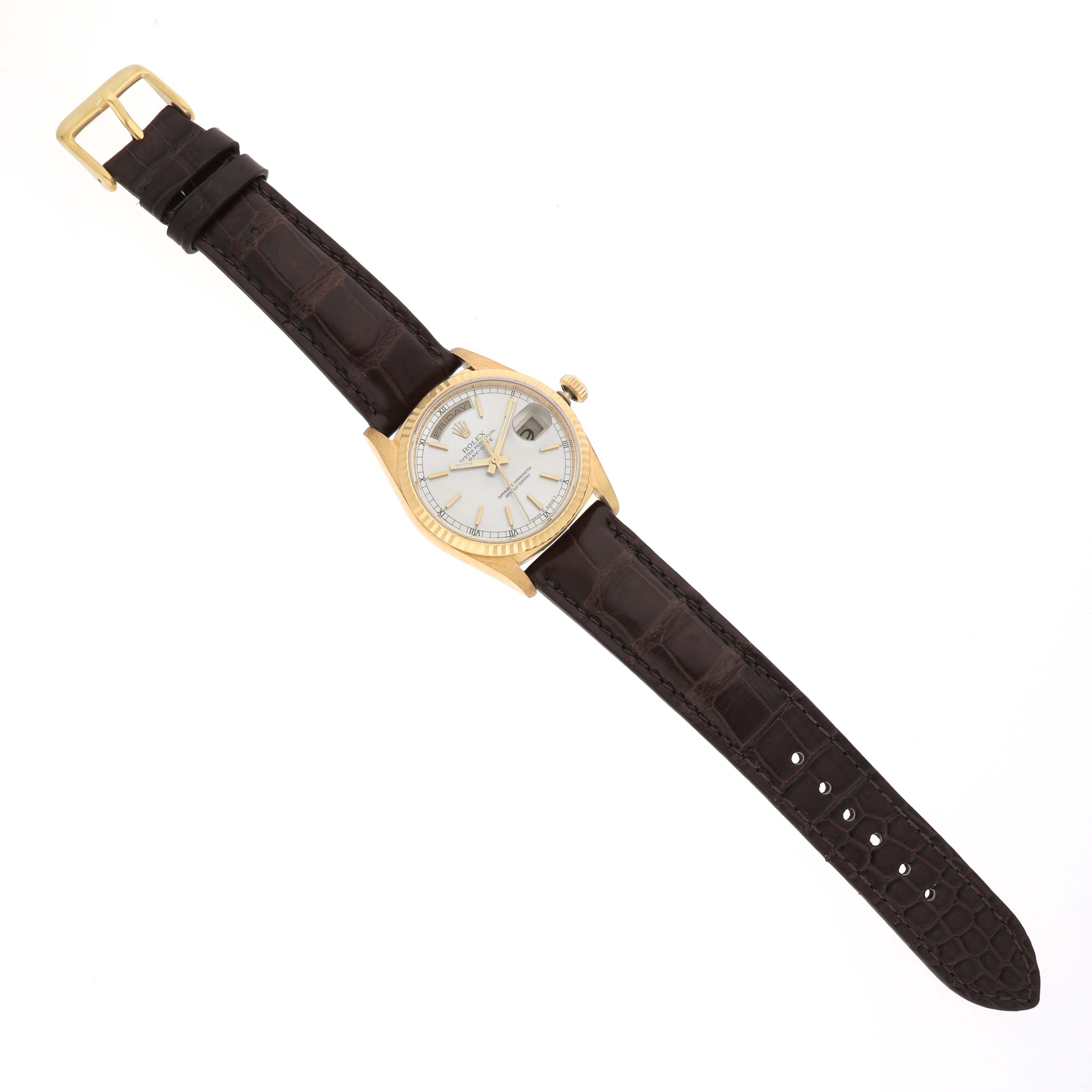 This image shows a Rolex President 18238 Men's Yellow Gold Silver Dial watch from a top-down angle, displaying the face, case, crown, and leather strap.