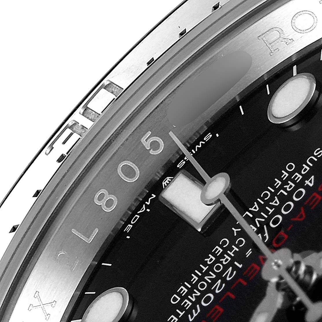This close-up image of the Rolex Sea-Dweller 126600 Men
s Stainless Steel Black Dial 126600 Men
s Stainless Steel Black Dial watch shows the upper part of the dial, bezel, and part of the hour marker.