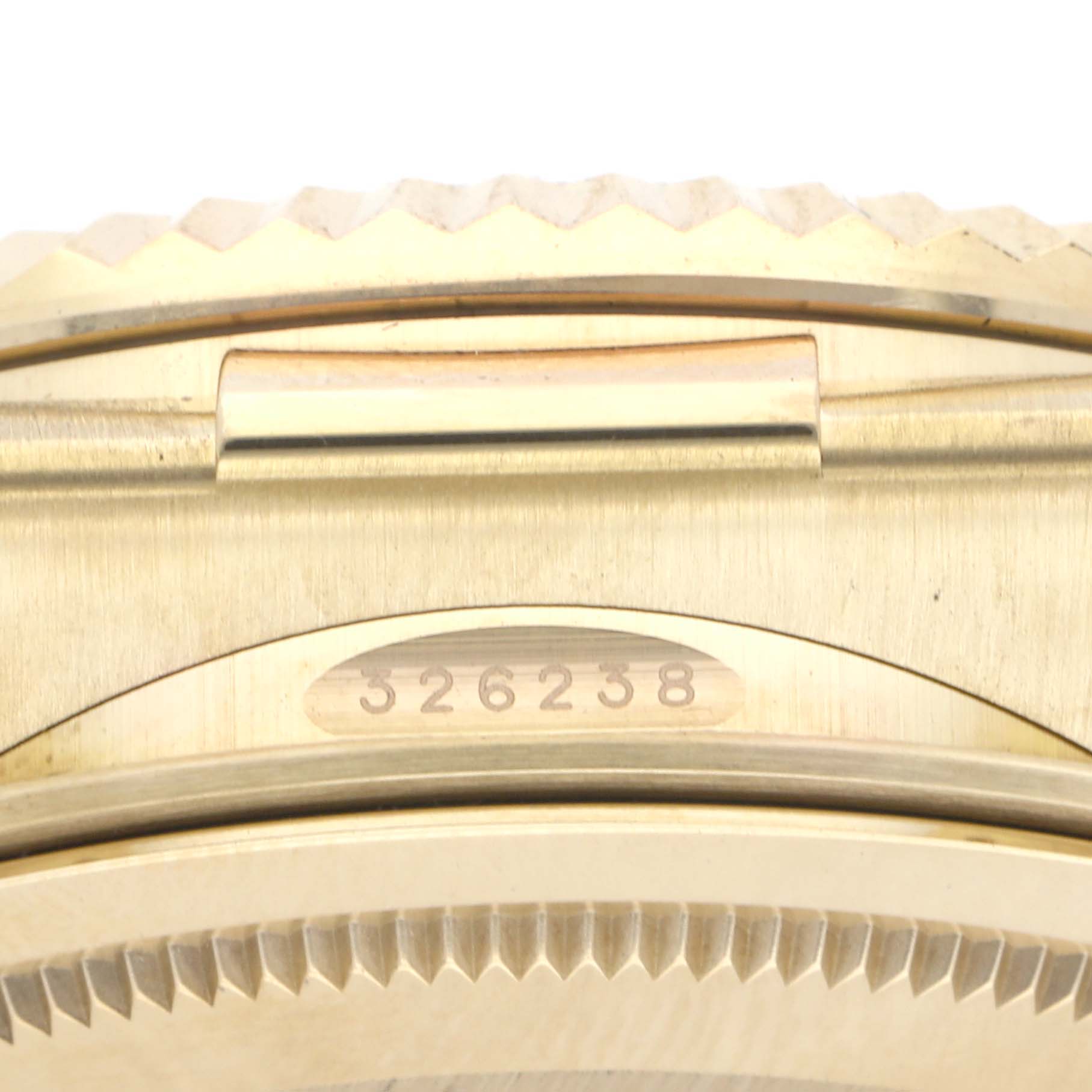 The image shows the side of the Rolex Sky-Dweller 326238 Men's Yellow Gold White Dial 326238 Men's Yellow Gold White Dial, focusing on the case edge and serial number.