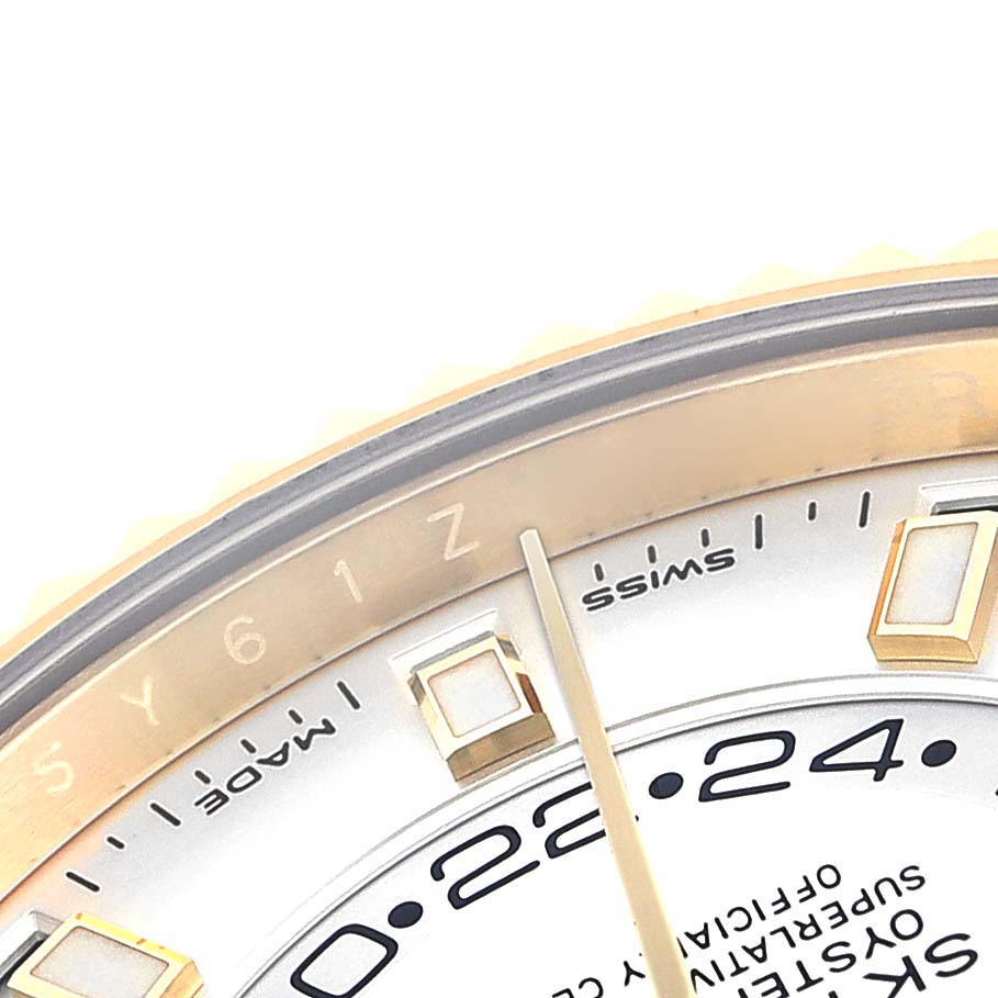 The image shows a close-up of the dial and outer edge of a Rolex Sky-Dweller 326238 Men's Yellow Gold White Dial 326238 Men's Yellow Gold White Dial watch, showcasing the hour markers and a portion of the bezel.