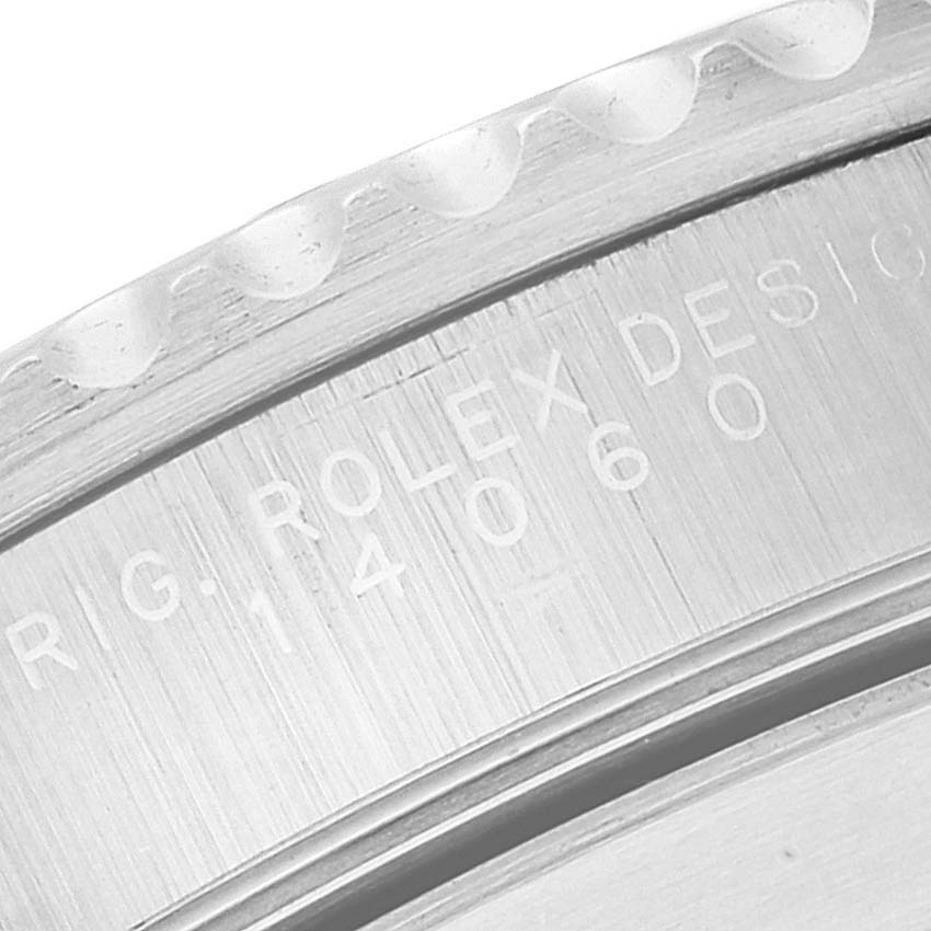 This image shows a close-up of the engraved model number "14060" on the side of a Rolex Submariner 14060 Men
s Stainless Steel Black Dial 14060 Men
s Stainless Steel Black Dial watch case.