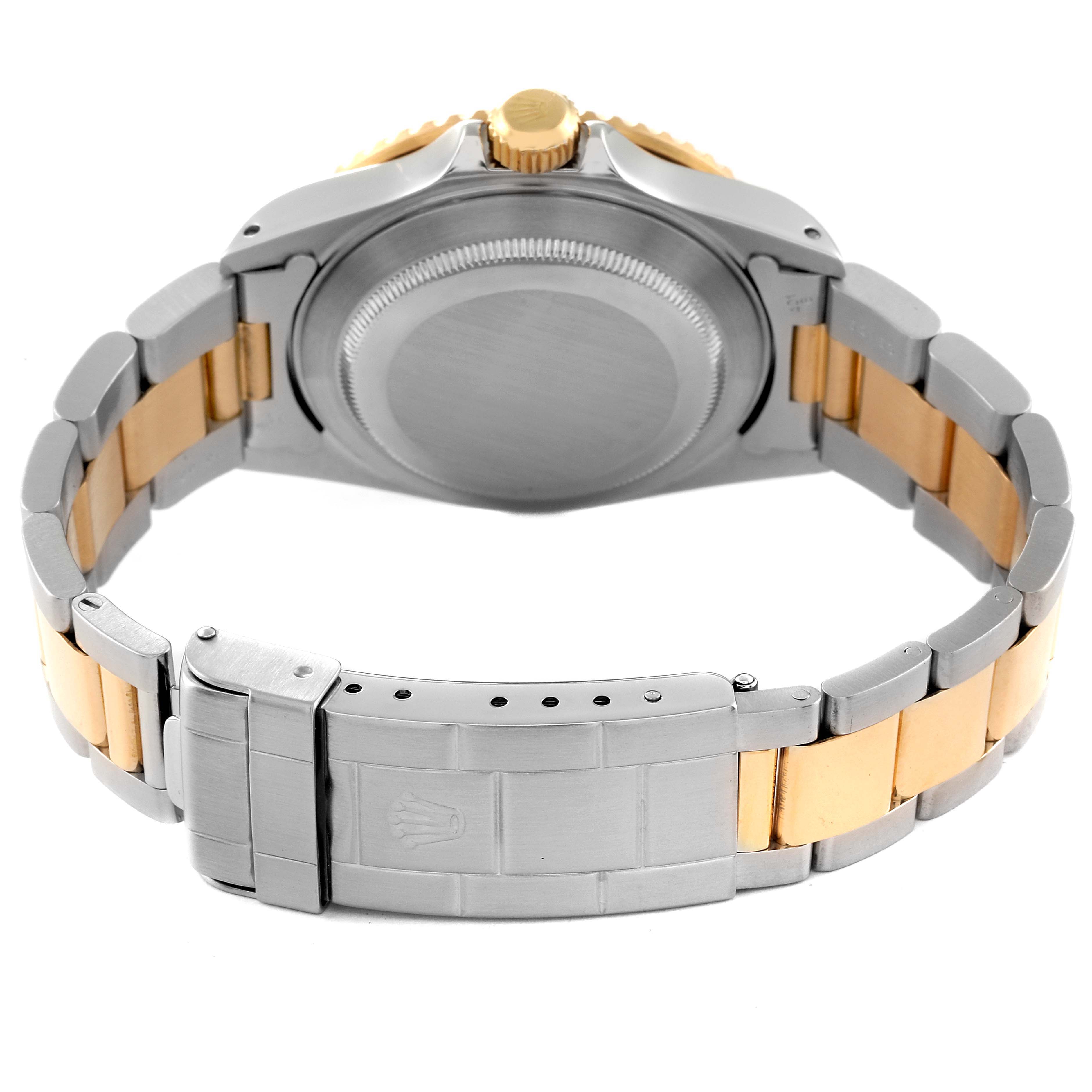 The image shows the back view of a Rolex Submariner 16613 Men's Steel and Gold (two tone) Blue Dial 16613 Men's Steel and Gold (two tone) Blue Dial watch, highlighting the clasp, bracelet, and case back.