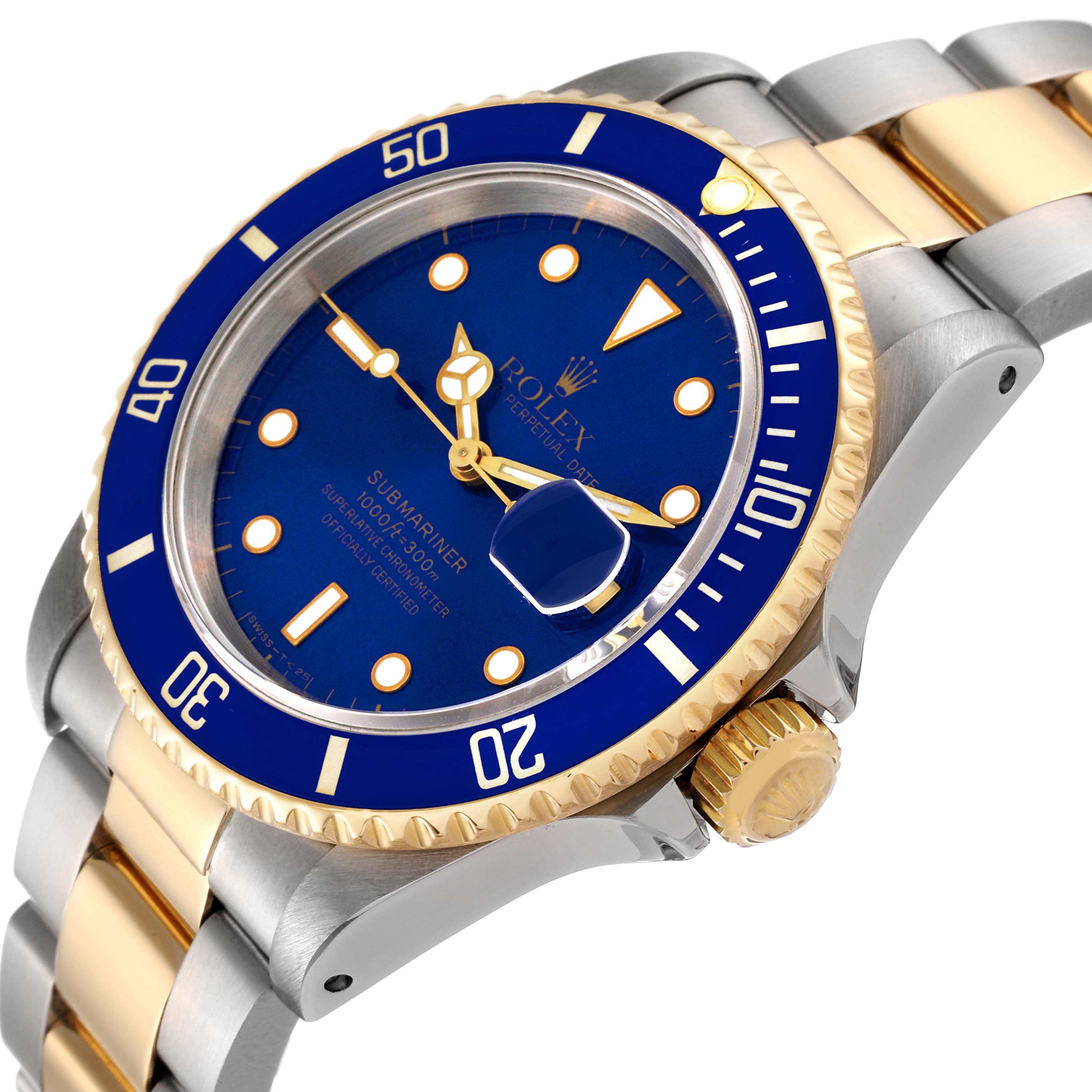 The image shows a close-up, angled view of a Rolex Submariner 16613 Men's Steel and Gold (two tone) Blue Dial 16613 Men's Steel and Gold (two tone) Blue Dial watch, highlighting the blue dial, bezel, and two-tone bracelet.