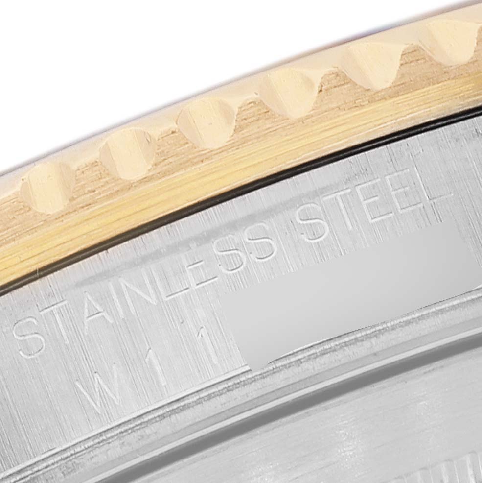 This is a close-up of the case back and bezel edge of a Rolex Submariner 16613 Men's Steel and Gold (two tone) Blue Dial 16613 Men's Steel and Gold (two tone) Blue Dial watch, showing the "STAINLESS STEEL" engraving.