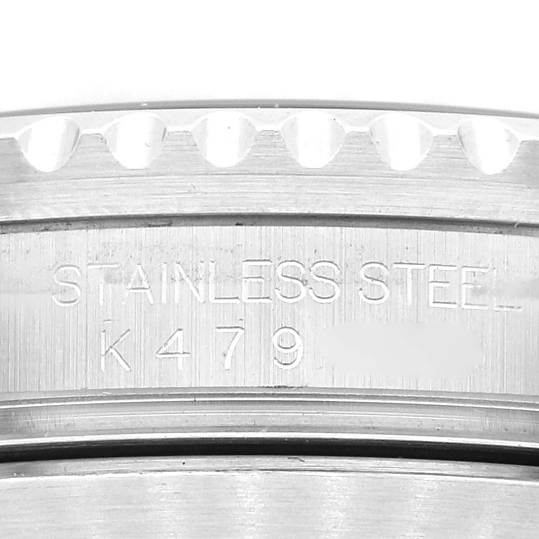 This close-up image shows a portion of the stainless steel bezel and engraved markings of a Rolex Submariner 16610 Men
s Stainless Steel Black Dial 16610 Men
s Stainless Steel Black Dial watch.