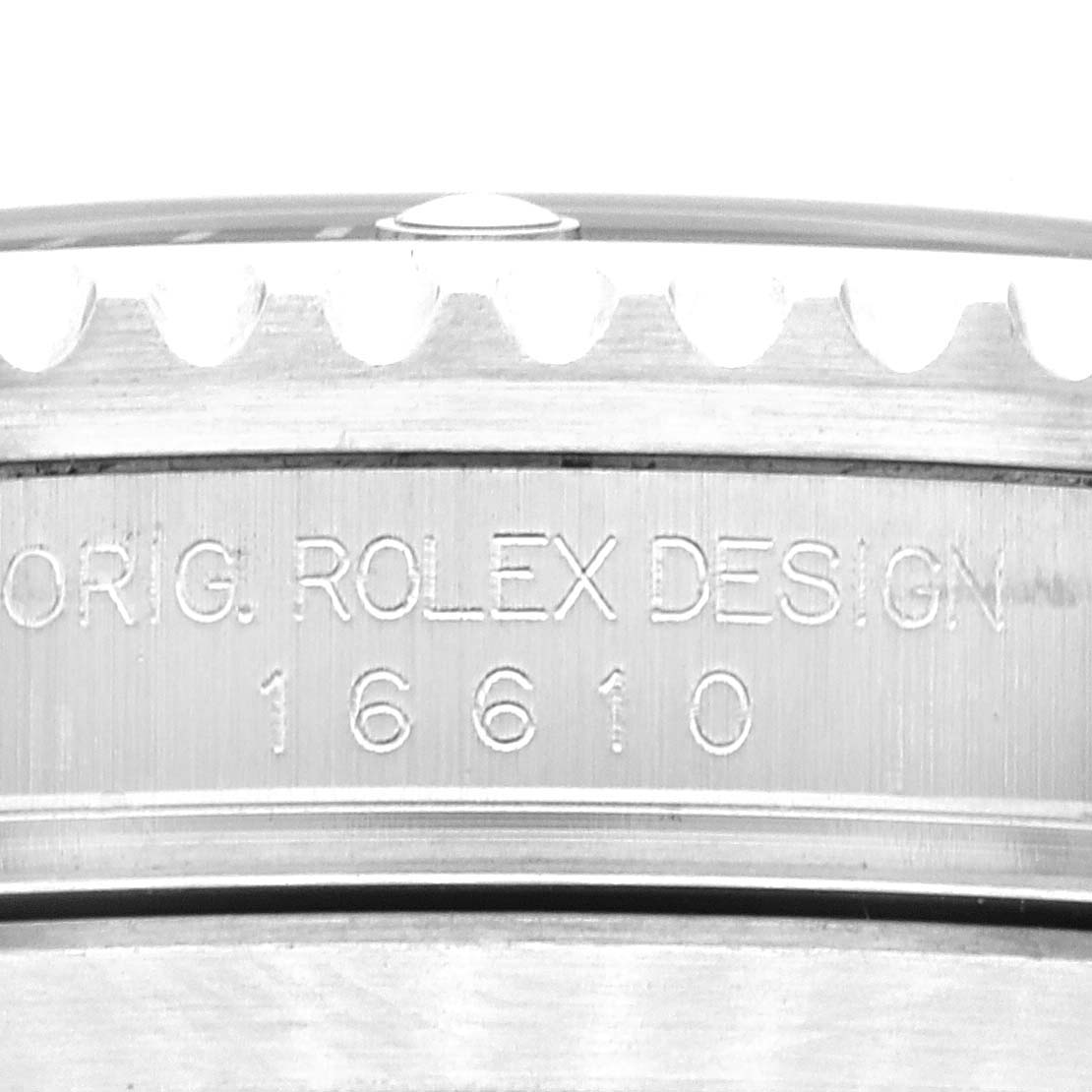 This image shows a close-up of the side of a Rolex Submariner 16610 Men
s Stainless Steel Black Dial 16610 Men
s Stainless Steel Black Dial watch, featuring the engraved model number 16610 and "ORIG. ROLEX DESIGN."