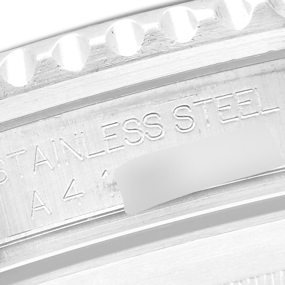 The image shows a close-up of the case back edge and engraving on a Rolex Submariner 16610 Men's Stainless Steel Black Dial 16610 Men's Stainless Steel Black Dial, highlighting "STAINLESS STEEL."