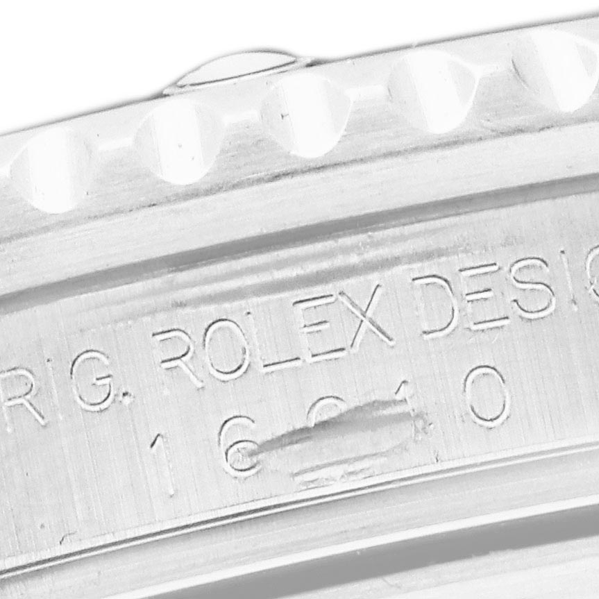The image shows a close-up of the inner bezel and case of a Rolex Submariner 16610 Men's Stainless Steel Black Dial 16610 Men's Stainless Steel Black Dial, featuring engraved text.