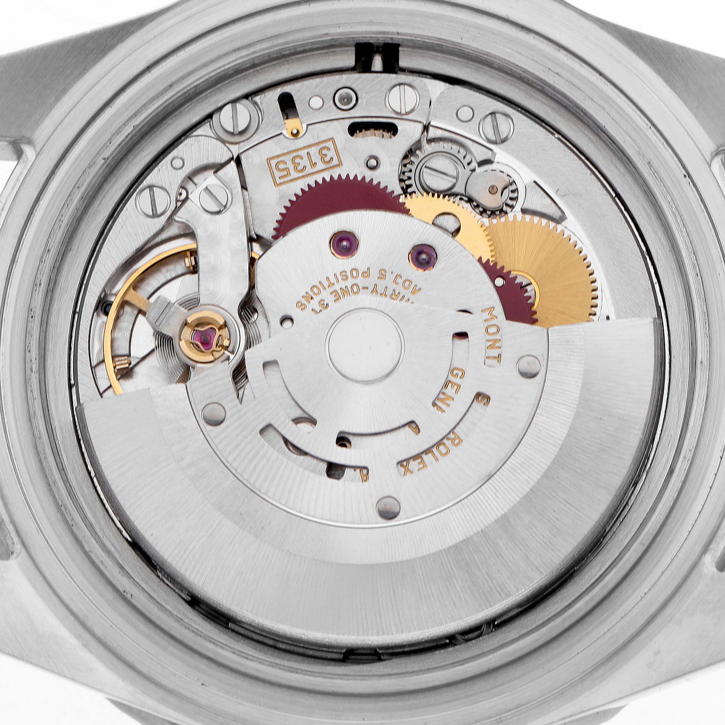 This image shows a close-up of the movement inside a Rolex Submariner 16610 Men's Stainless Steel Black Dial, highlighting gears and mechanical components.