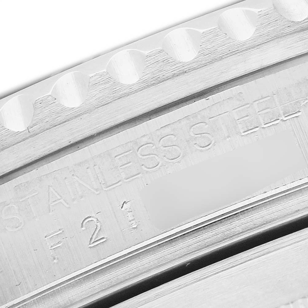 The image shows a close-up of the engraved side of the bezel and case for the Rolex Submariner 16610 Men's Stainless Steel Black Dial, highlighting "STAINLESS STEEL."