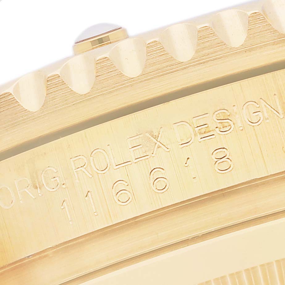 The image shows a close-up of the engraved side of the Rolex Submariner 116618 Men's Yellow Gold Black Dial 116618 Men's Yellow Gold Black Dial's case, highlighting model and branding details.
