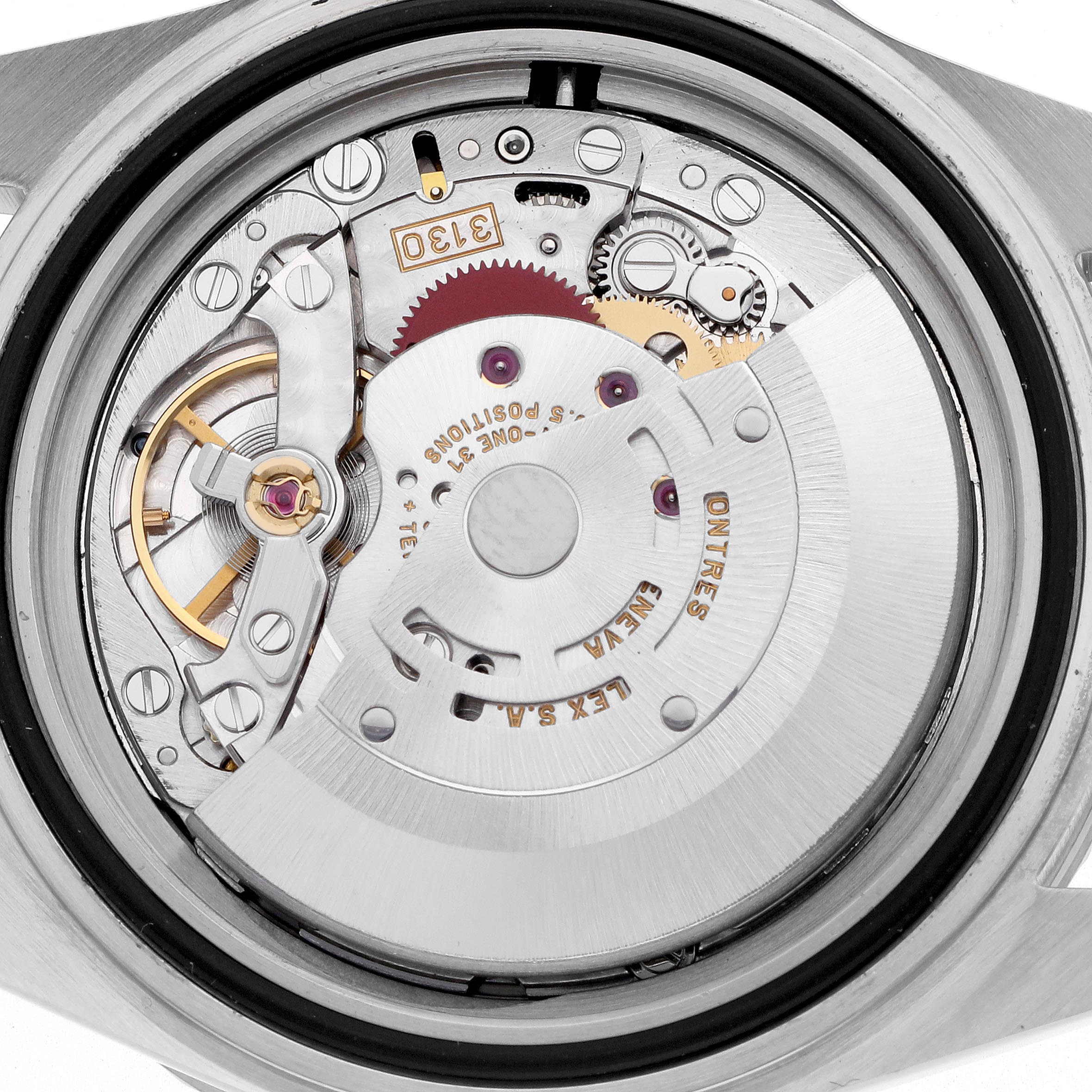 The image shows the movement of a Rolex Submariner 14060 Men's Stainless Steel Black Dial 14060 Men's Stainless Steel Black Dial watch from a top-down angle, highlighting internal components and gears.